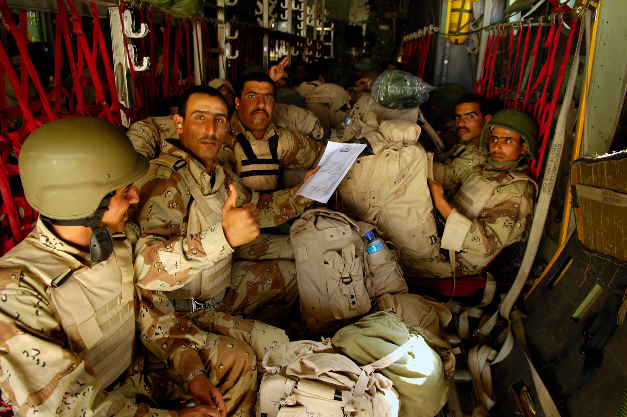 Members of the Iraqi army sit in an Iraqi C-130 Hercules before a March 30 flight to Basra, Iraq, at New Al Muthana Air Base, Iraq. All processing, loading and transporting of the Iraqi troops is being conducted by the Iraqi air force.  (U.S. Air Force photo/Tech. Sgt. Jeffrey Allen)