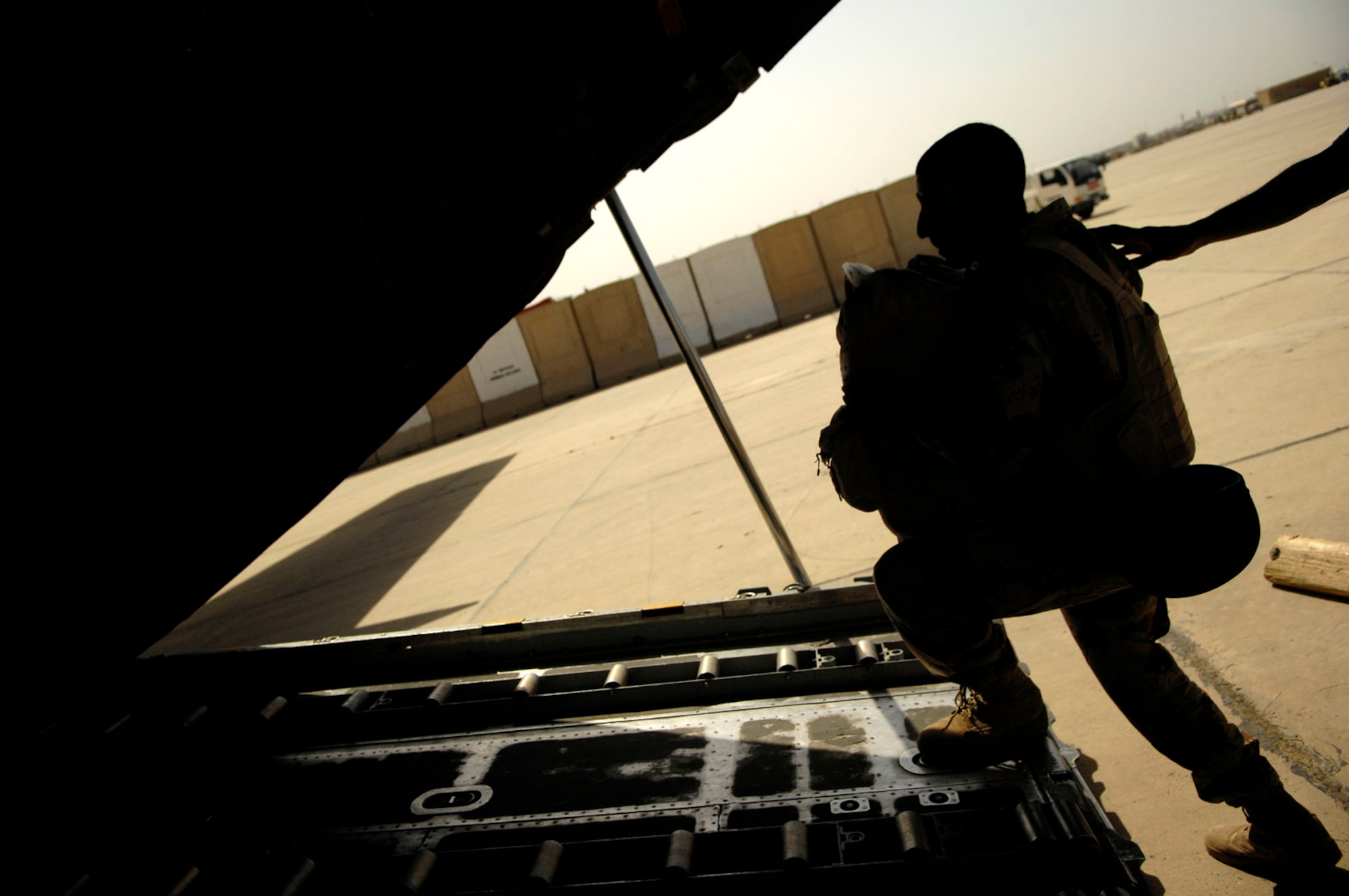 A member of the Iraqi army boards an Iraqi C-130 Hercules for a March 30 flight to Basra, Iraq, at New Al Muthana Air Base, Iraq. All processing, loading and transporting of the Iraqi troops is being conducted by the Iraqi air force. (U.S. Air Force photo/Tech. Sgt. Jeffrey Allen) 
