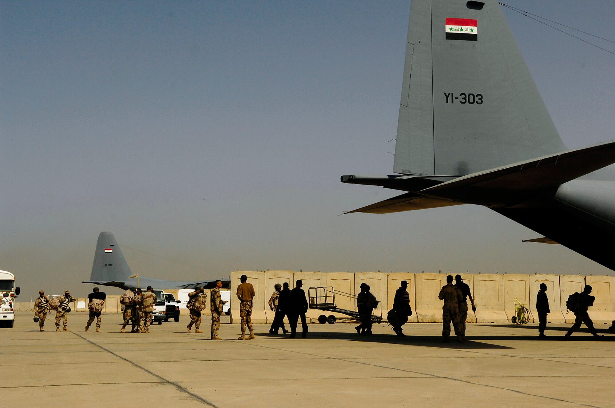 Members of the Iraqi army sit on an Iraqi C-130 Hercules before a March 30 flight to Basra, Iraq, at New Al Muthana Air Base, Iraq. All processing, loading and transporting of the Iraqi troops is being conducted by the Iraqi air force. (U.S. Air Force photo/Tech. Sgt. Jeffrey Allen) 
