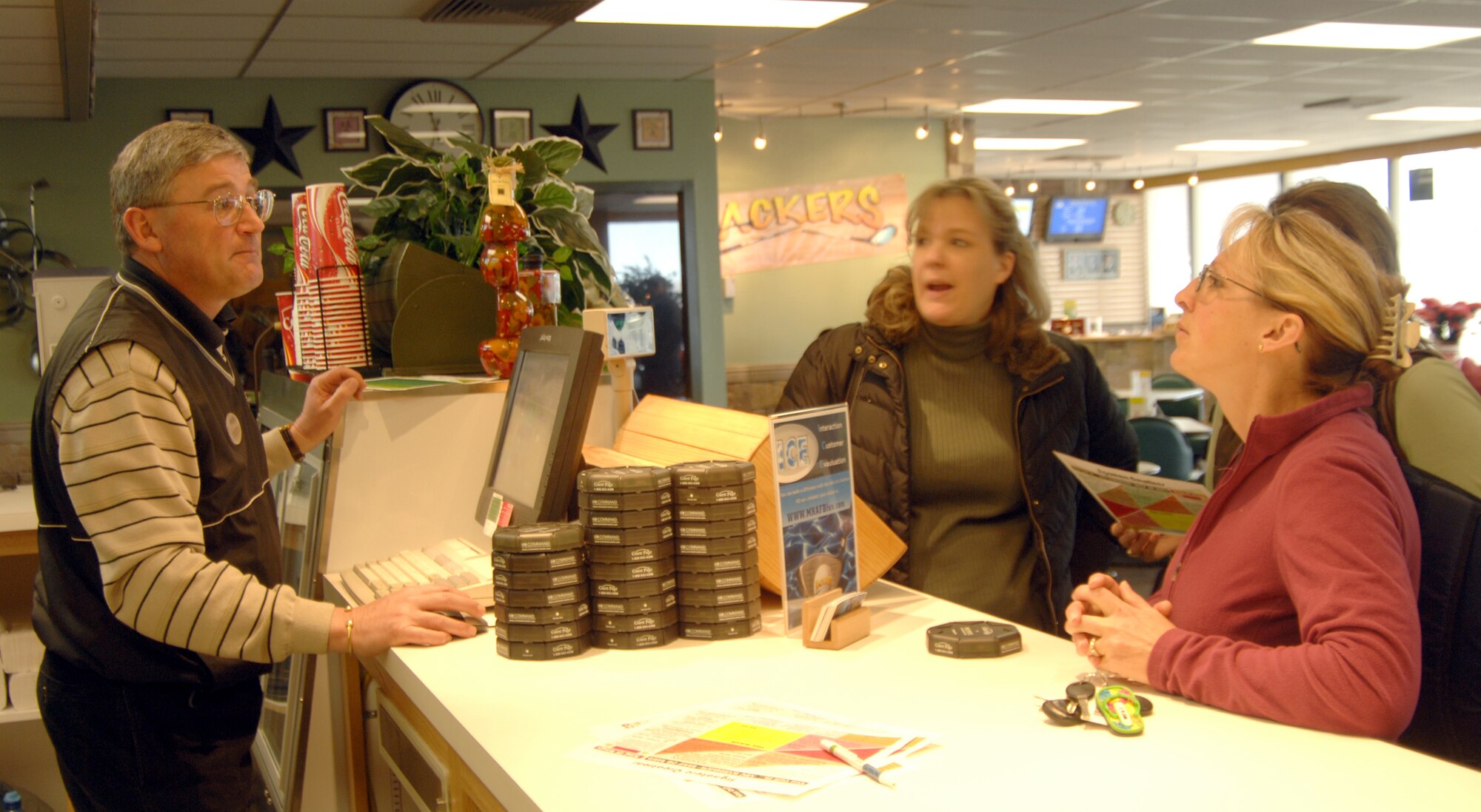 MOUNTAIN HOME AIR FORCE BASE, Idaho – Ray Newman, Silver Sage Golf Course manager, takes a lunch order from Jenna Beaty, Gunfighter spouse, at the recently renovated Silver Sage Golf Course Hacker Deli during its reopening April 1. Renovations at the clubhouse include a newly designed interior, which offers a bistro-style deli and golf shop, a larger selection of food to include healthier meals and new hours of operation. After using allotted funds from the 2007 Commander-in-Chief's Annual Award for Installation Excellence, the 366th Services Squadron finished the project with their own funds and labor. (U.S. Air Force photo/Staff Sgt. Brian Stives)