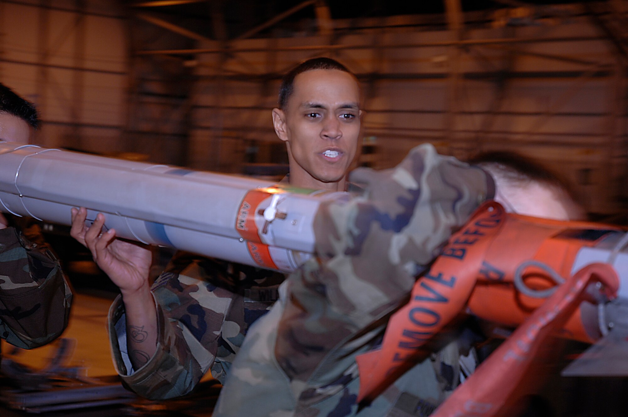 Staff Sgt Victor Williams, 493rd Aircraft Maintenance Unit, assists in taking a munition to an F-15C to be loaded during the annual weapons load crew competition at RAF Lakenheath, March 14. The competition is between four quarterly winners for the title of the best in the wing out of 47 weapons load crews. (U.S. Air Force photo by Senior Airman Brian J. Ellis) 