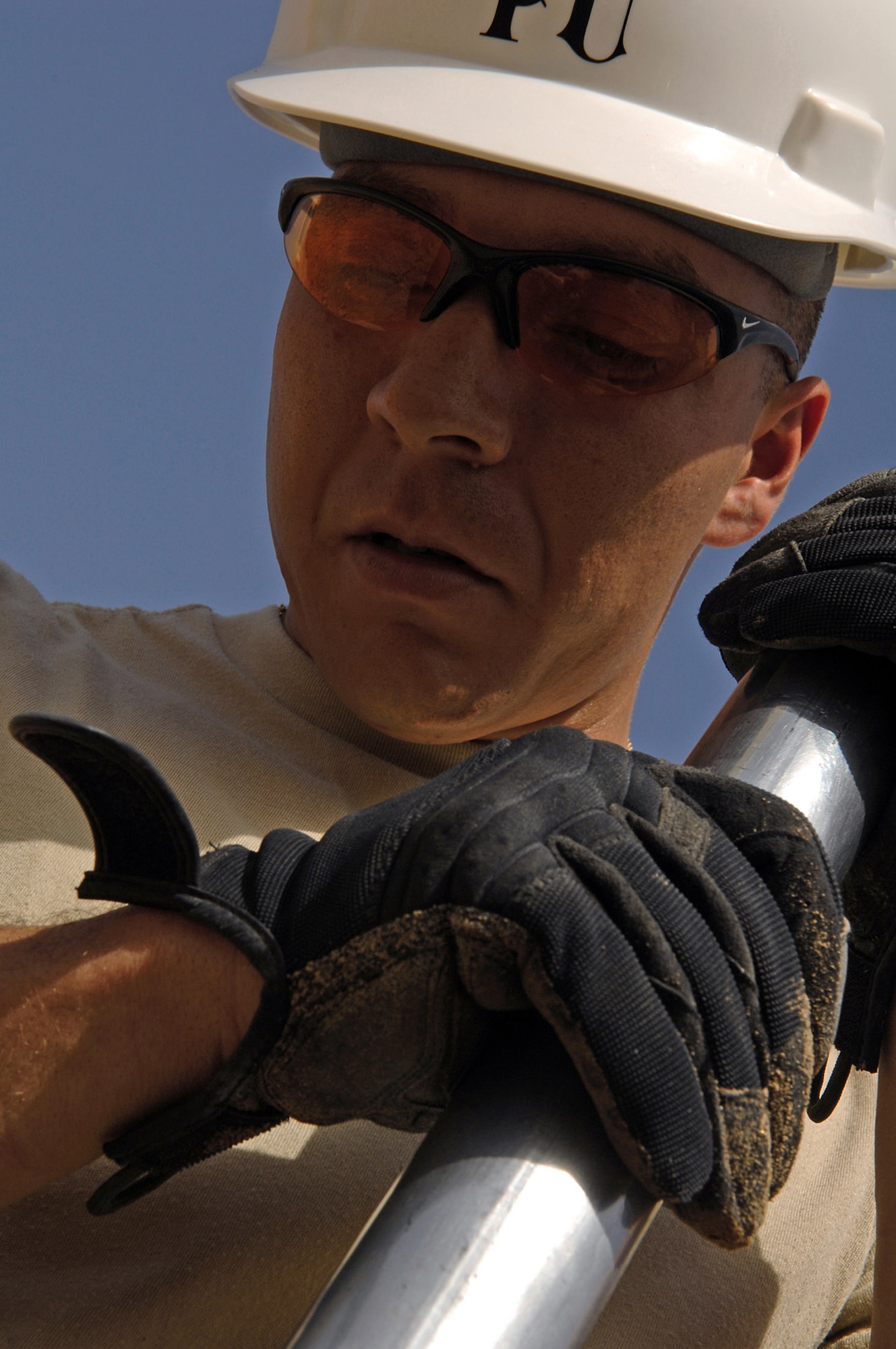 Staff Sgt. Steven Lucero compacts sand around water pipes to provide protection from rocks March 24 at Balad Air Base, Iraq. Base plumbers are in the midst of a pipe infrastructure replacement project involving removal of old pipes and replacing them with newer, thicker gauge pipes that will stabilize the systems. Sergeant Lucero is a 332nd Civil Engineer Squadron plumber deployed from Ellsworth Air Force Base, S.D. (U.S. Air Force photo/Senior Airman Julianne Showalter) 
