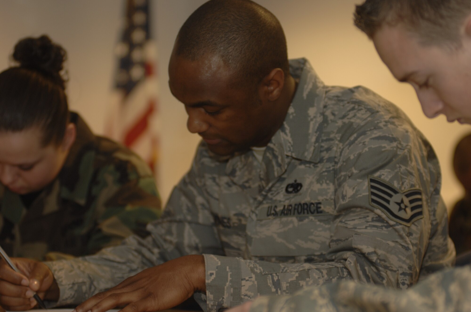 Staff Sgt. Iickyra Jones, 48th Aircraft Maintence Squadron,  completes a written test as part of the 48th Fighter Wing annual load crew competition, Mar. 14, RAF Lakenheath, England. Airmen are judged on their uniform and military bearing, a written test and then a hands on assessment of loading AIM-9s and GBU-12s onto aircraft. (U.S. Air Force photo by: A1C Erika Brooke)