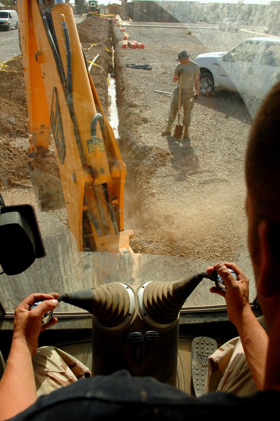 Staff Sgt. John Hampsey excavates dirt from a water main site in the Air Force housing area March 25 at Balad Air Base, Iraq. The 332nd Civil Engineer Squadron utilities shop Airmen are in the process of replacing old pipes and installing newer and thicker pipes that will bring the base to the next echelon of stability. Sergeant Hampsey is a 332nd CES plumber deployed form Luke Air Force Base, Ariz. (U.S. Air Force photo/Senior Airman Julianne Showalter) 