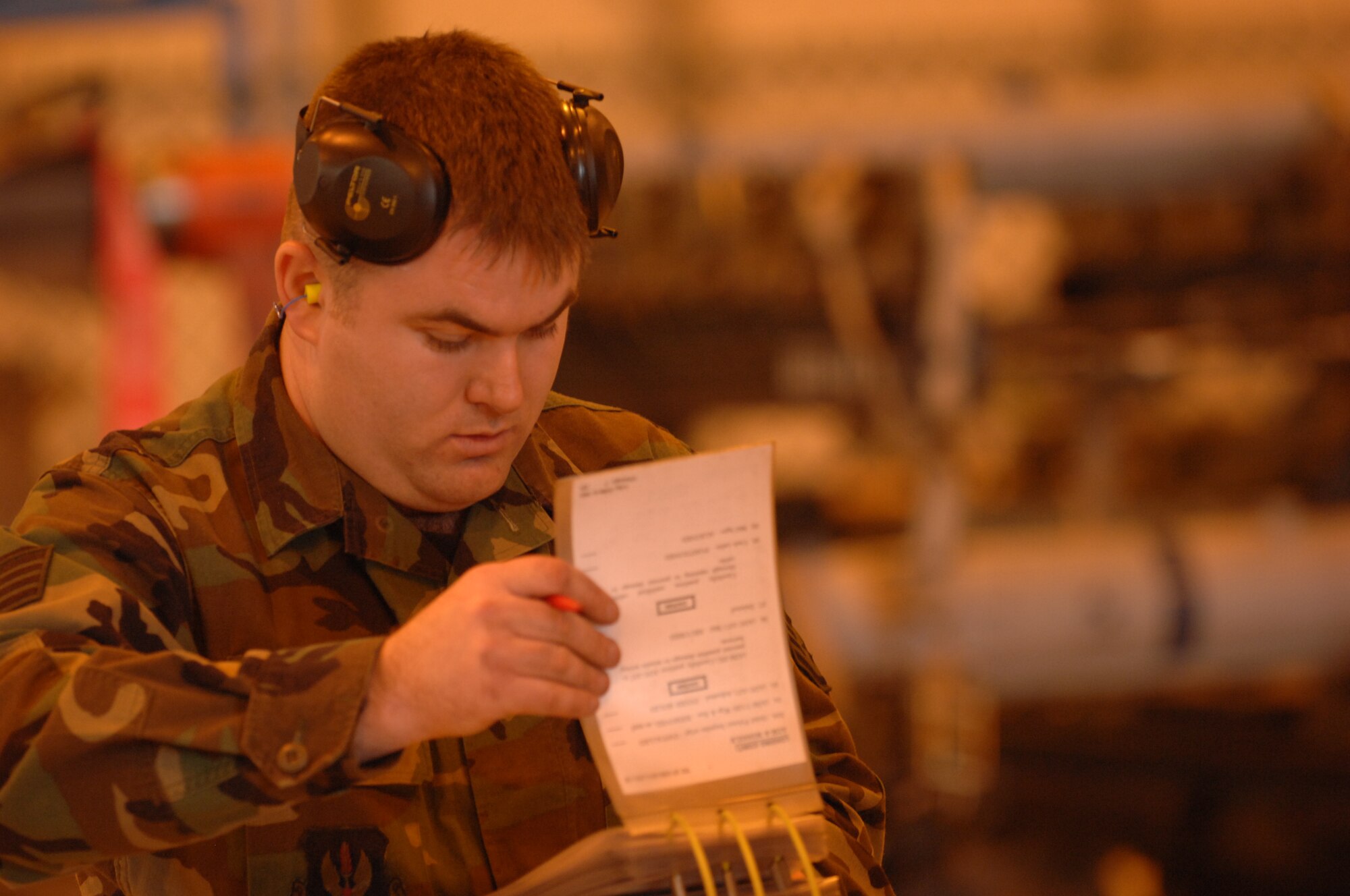Staff Sgt. William Cole, 493rd Aircraft Maintenance Unit, reviews his weapons loading checklist prior to loading ordnance onto an F-15C Eagle. His crew, Crew 75, won the annual weapons load crew competition held at RAF Lakenheath, March 14. The competition is between four quarterly winners for the title of the best in the wing out of 47 weapons load crews. (U.S. Air Force photo by Airman 1st Class John Easterling)