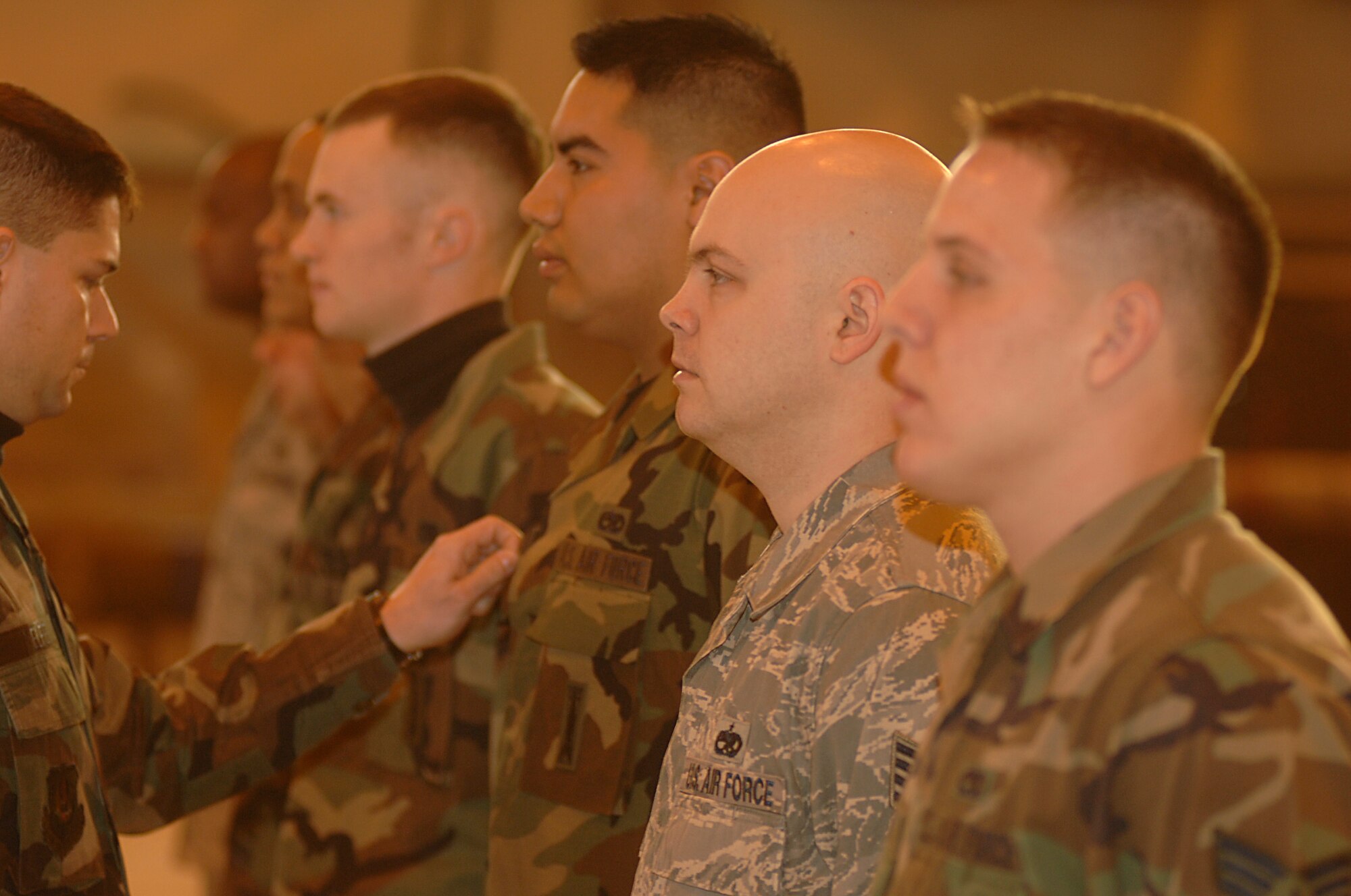 Chief Master Sgt. James Melfie, 48th Fighter Wing weapons manager, performs open ranks inspection on 48th Aircraft Maintence Squadron troops as part of the 48th FW annual load crew competition, Mar. 8, RAF Lakenheath, England. Airmen are judged on their uniform and military bearing, a written test and then a hands on assessment of loading AIM-9s and GBU-12s onto aircraft. (U.S. Air Force photo by Airman 1st Class Erika Brooke)