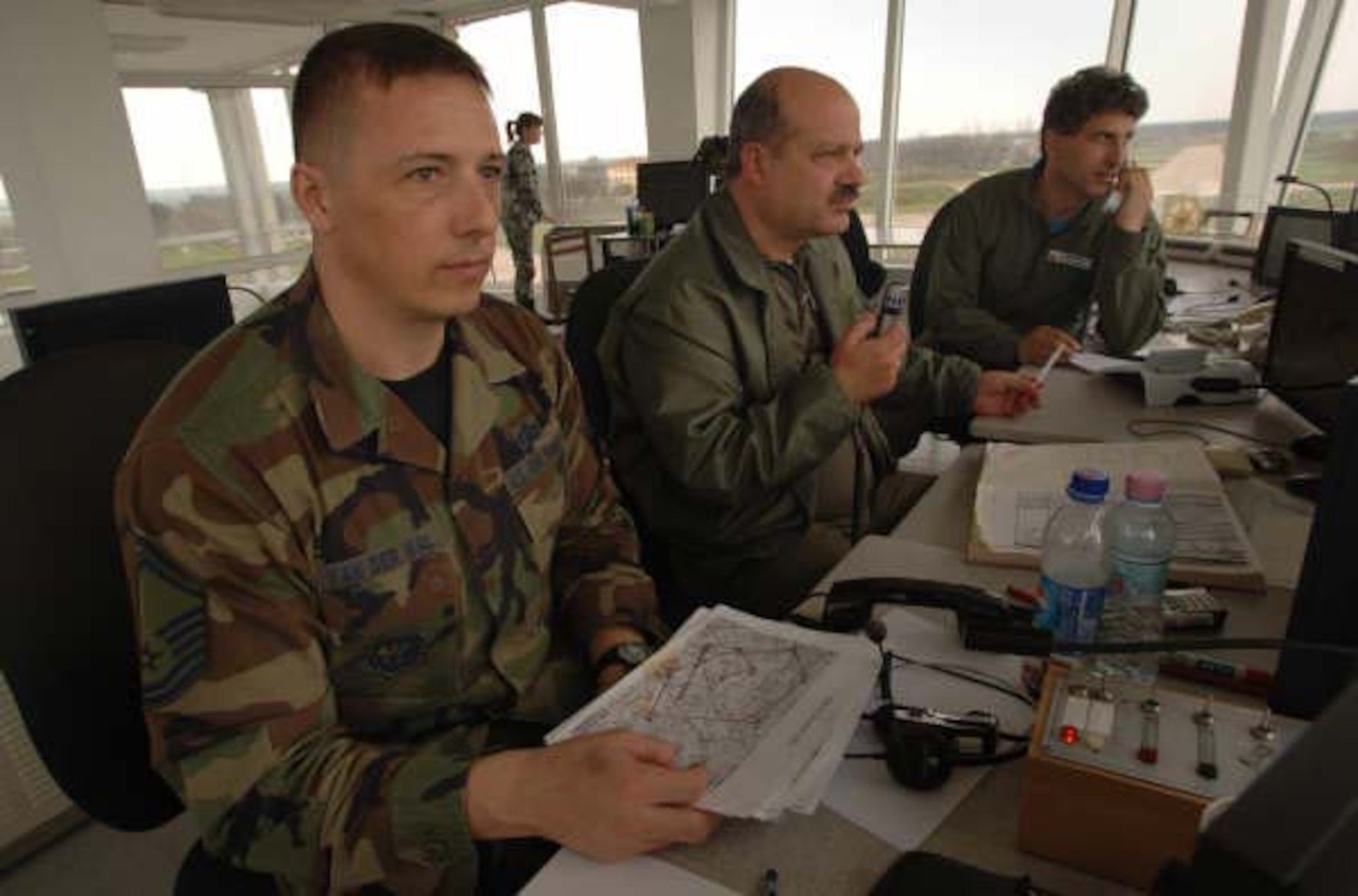 Air traffic control liaison, Master Sgt. Matthew Van Der Wal works with Bulgarian air traffic controllers Major's Stoyan Stoichev and Valentin Makedonsky in the tower at Bezmer Air Base, Bulgaria. Four Hercules from the 37th Air Lift Squadron and approximately 170 aircrew and support personnel assigned to the 86th Air Lift Wing and 435th Air Base Wing at Ramstein Air Base, Germany are being hosted by the Bulgarian Air Force for the annual bilateral training exercise between the United States and Bulgaria. Photo by Master Sgt. Scott Wagers / (released)

