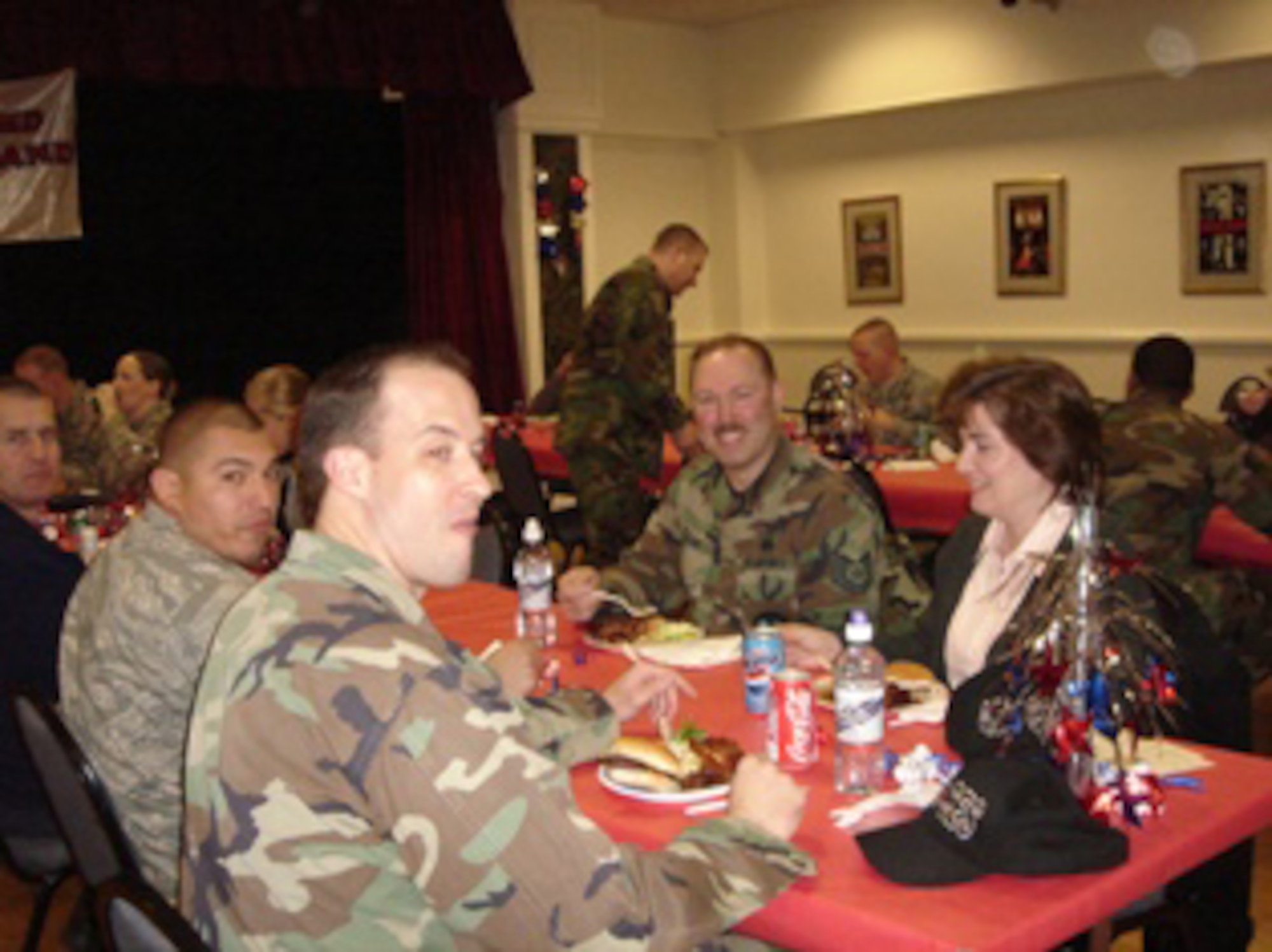 Tech. Sgt. Kenneth Payne, Diane Payne and Staff Sgt. David Garcia enjoy a BBQ lunch at the RAF Alconbury Welcome Home luncheon Feb. 21 in the Community Activities Center.  This event was coordinated by the Alconbury Airman and Family Readiness Center in support of 501st Combat Support Wing staff and 423rd Air Base Group personnel who recently returned from deployment.  Sergeants Payne and Garcia were among 27 Airmen who were welcomed home following their deployments in support of Operations Iraqi and Enduring Freedom. (U.S. Air Force photo)