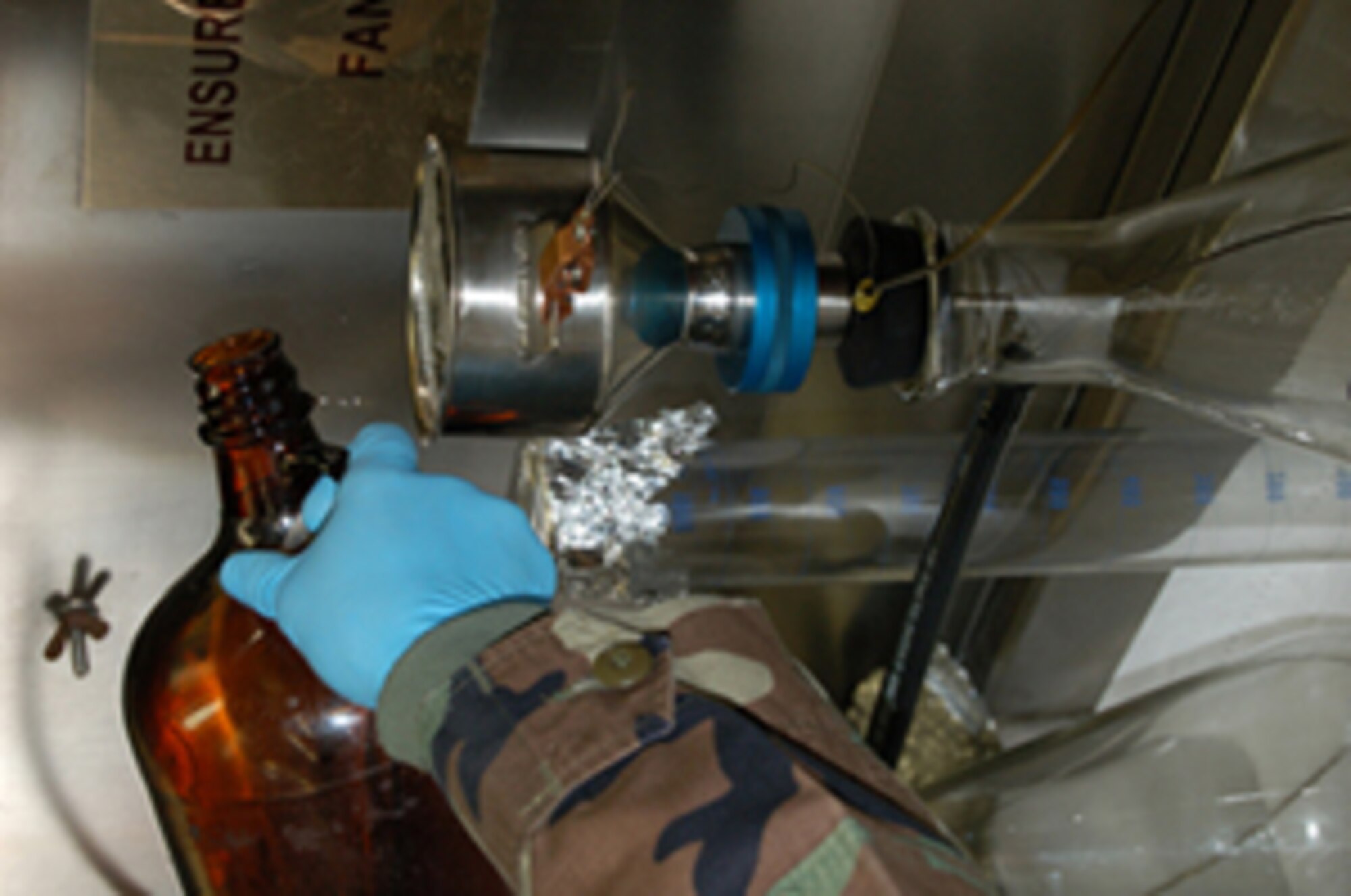 SPANGDAHLEM AIR BASE, Germany – Airman 1st Class Darren Albrecht, 52nd Logistics Readiness Squadron fuel laboratory technician, performs a bottle method test. In the Air Force, this test is used to determine the solid content of the fuel and the time it takes for the fuel to pass through the filter. This method is the most accurate way to test for solids in fuel. (U.S. Air Force photo/Staff Sgt. Tammie Moore)