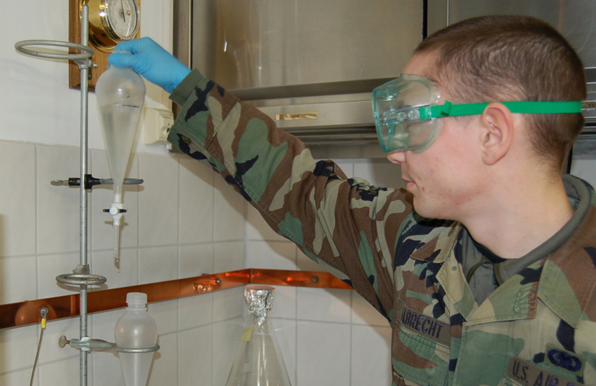 SPANGDAHLEM AIR BASE, Germany – Airman 1st Class Darren Albrecht, 52nd Logistics Readiness Squadron fuel laboratory technician, finishes shaking fuel and water together for five minutes. Water is added to the fuel for this test because it traps the fuel system icing inhibitor, pulling it out of the fuel. After two minutes he will learn the FSII level on a refratometer. (U.S. Air Force photo/Staff Sgt. Tammie Moore)