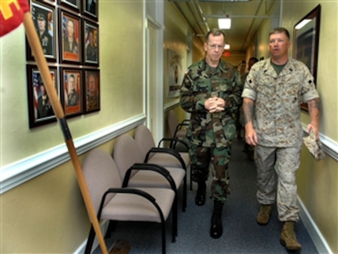 Chairman of the Joint Chiefs of Staff Navy Adm. Mike Mullen takes a tour of living conditions for Wounded Warrior Battalion East from Marine Master Sgt. Ken Barnes during a visit to Camp Lejeune, N.C., April 1, 2008. 