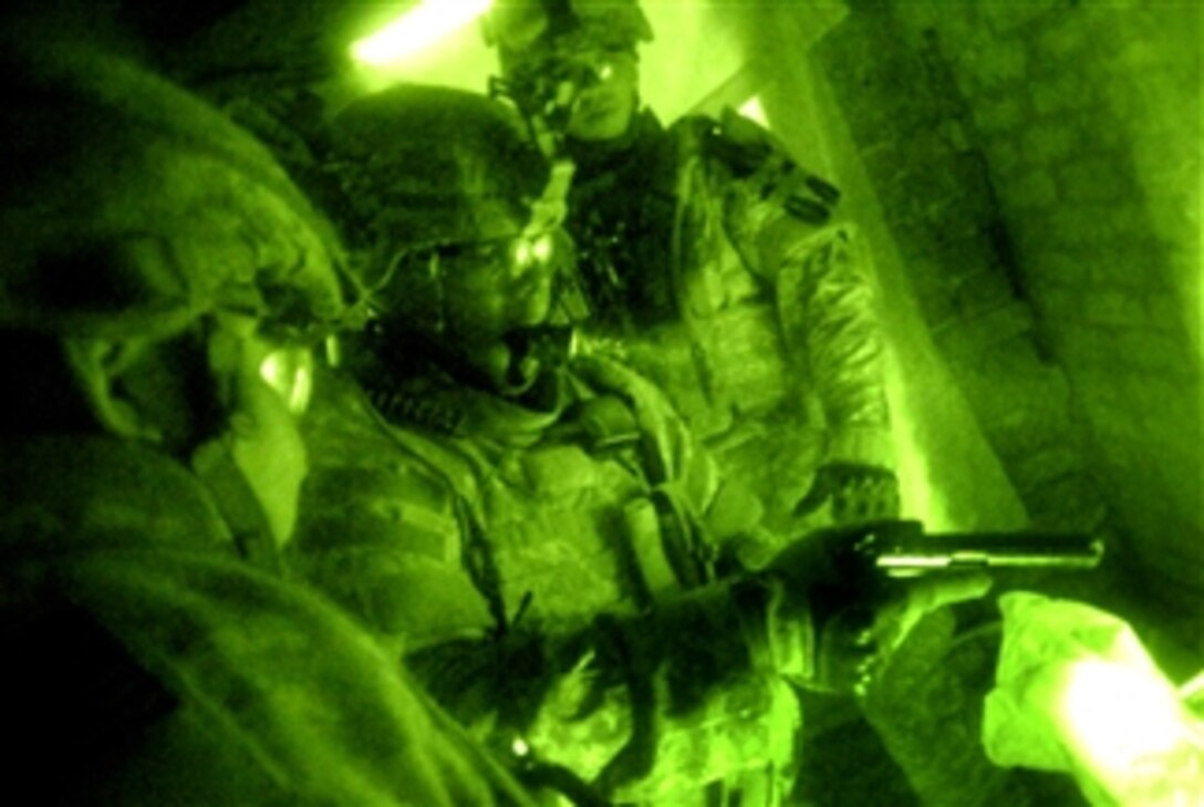 U.S. Army soldiers clear a weapon they discovered during a patrol in Karadah, Iraq, March 19, 2008. The soldiers are assigned to the 10th Mountain Division's Battery B, 5th Battalion, 25th Field Artillery Regiment.