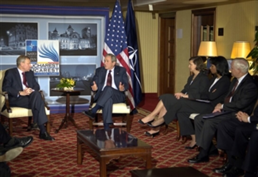 NATO Secretary General Jaap de Hoop Scheffer listens to remarks from U.S. President George W. Bush in Bucharest, Romaina, as U.S. Ambassador to NATO Victoria Nuland, Secretary of State Condoleezza Rice and Defense Secretary Robert M. Gates look on, April 2, 2008. They are taking part in the NATO Bucharest Summit. 