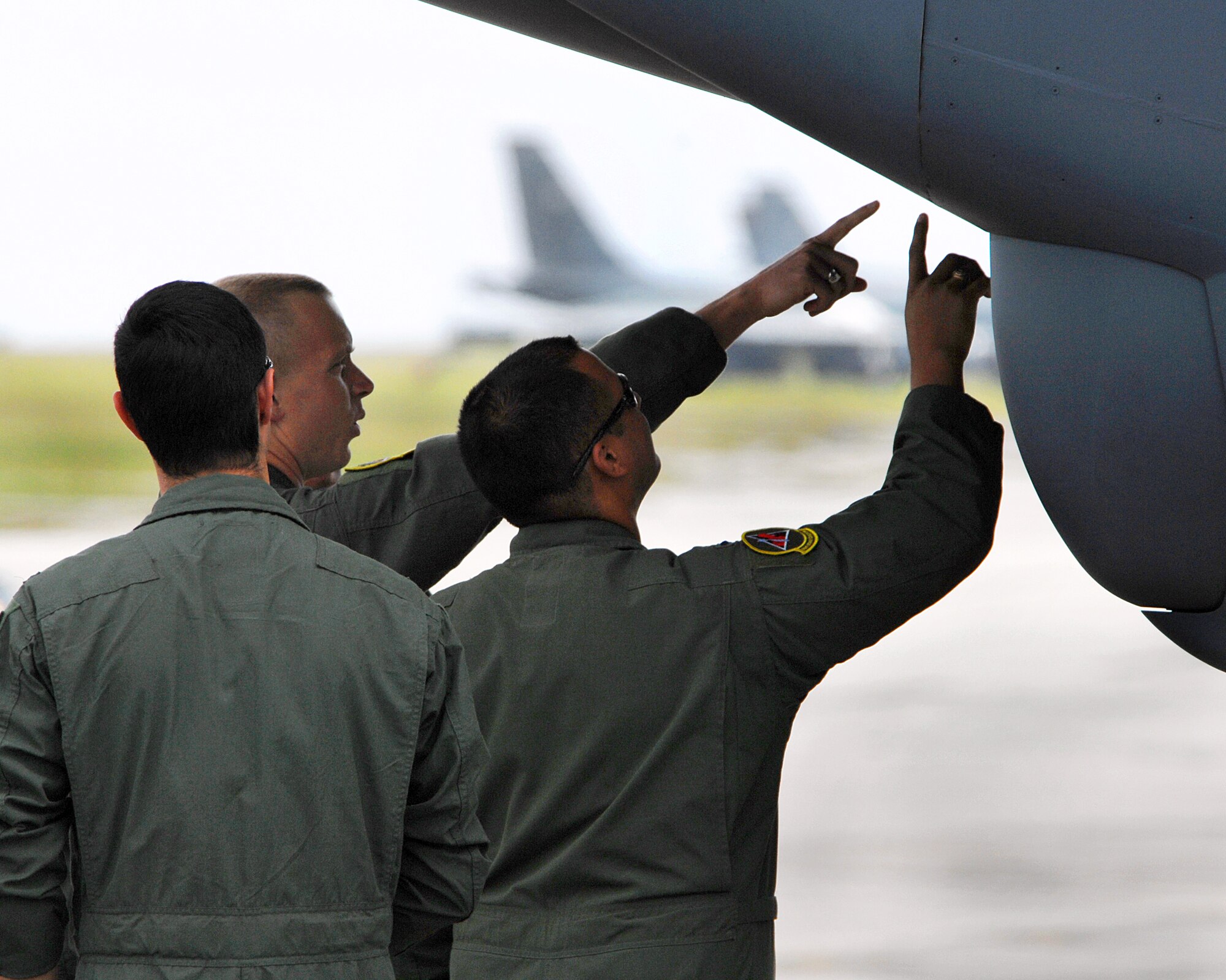 Andersen Air Force Base, Guam -- Aircrew from the 96th Expeditionary Bomb Squadron check out the nose radome of a B-52 Stratofortress before taking off on a training mission at Andersen Air Force Base, Guam. The 96th Expeditionary Bomb Squadron deployed from Barksdale AFB, La. (U.S. Air Force photo/Staff Sgt. Vanessa Valentine)
