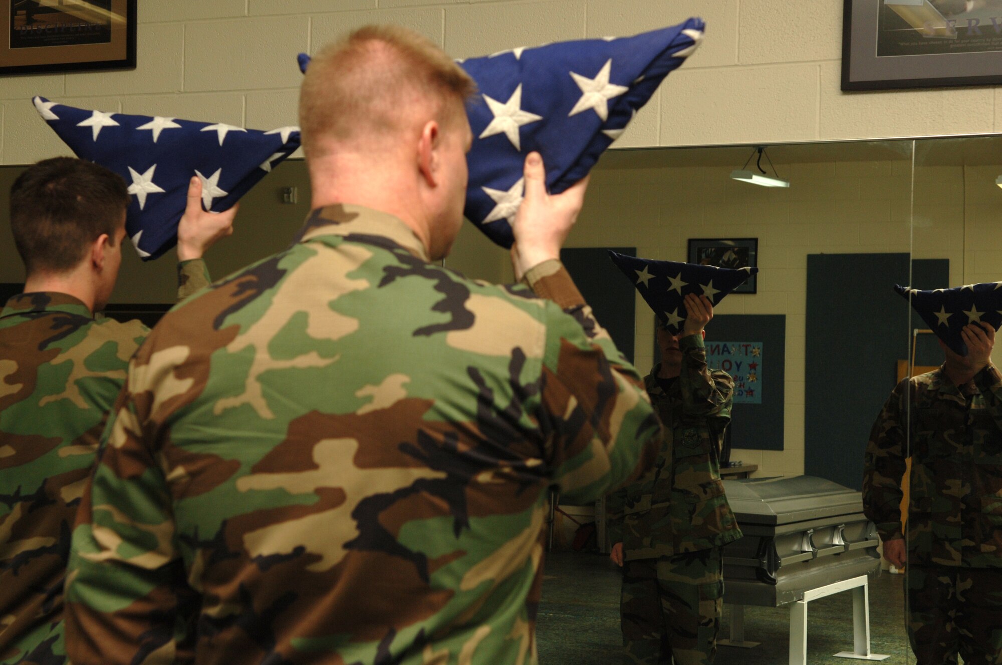 FAIRCHILD AIR FORCE BASE, Wash. – Officers and enlisted alike train to properly dress the flag before it is presented during any ceremony. Presenting the flag is an important part of any funeral ceremony because of the lasting impact imposed upon the recipient. (U.S. Air Force photo / Senior Airman Jocelyn Ford)
