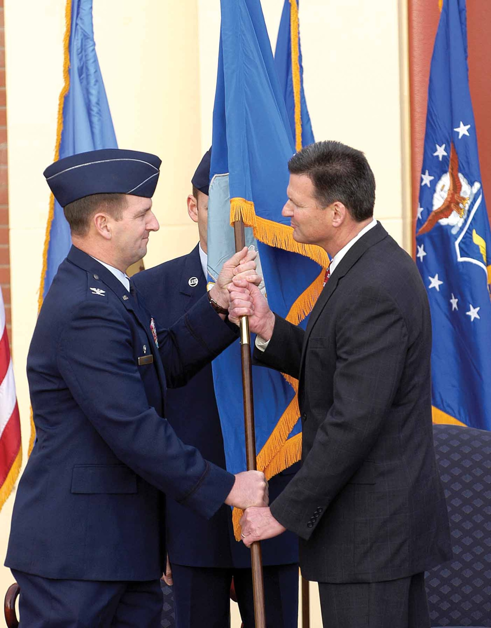 In a traditional ceremony, history is made Wednesday at Tinker as Col. H. Brent Baker Sr. confers leadership of the new 448th Supply Chain Management Wing to M. Scott Reynolds.  Col. Baker is the first commander of the Air Force Global Logistics Support Center, Scott Air Force Base, Ill.  (Air Force photo by Margo Wright)