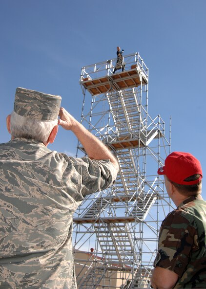 Gen. Arthur Lichte (left) Commander, Air Mobility Command, along with Lt. Col. Scott Hoover (right), Commander, 60th Civil Engineer Squadron, watch as firefighters from Travis Air Force Base, Calif. show what a typical practice consists of. General Lichte was impressed with the teams' remarkable dedication and their winning the World Championship title four years in a row.  (U.S. Air Force photo by: Civ/Laura Fentress)