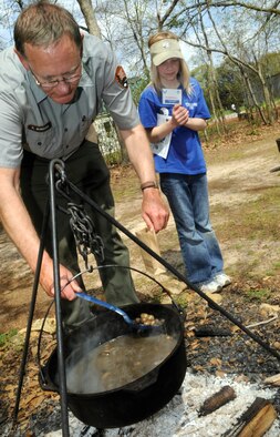 Kenny Wiseman, farm manager at Jimmy Carter's childhood farm, dips some boiled peanuts for Kendall Raley, 9.   U. S. Air Force photo by Sue Sapp