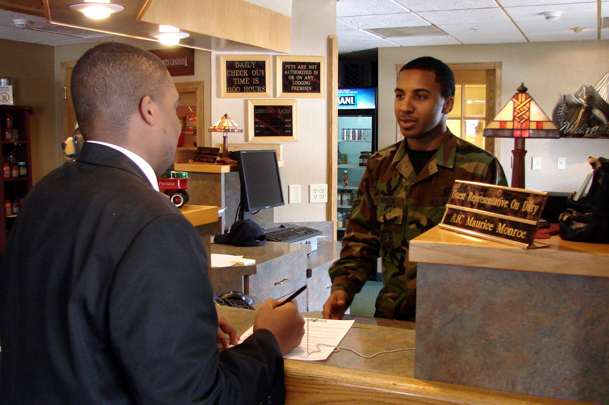 Airman 1st Class Maurice Monroe, 341st Services Squadron, assists Mr. Antonio Hicks check into the Malmstrom Inn April 1.  The Services Squadron will be evaluated for the Air Force-level Maj. Gen. Eugene L. Eubank Award April 7 to 11. (U.S. Air Force Photo/2nd Lt. Korry Leverett)