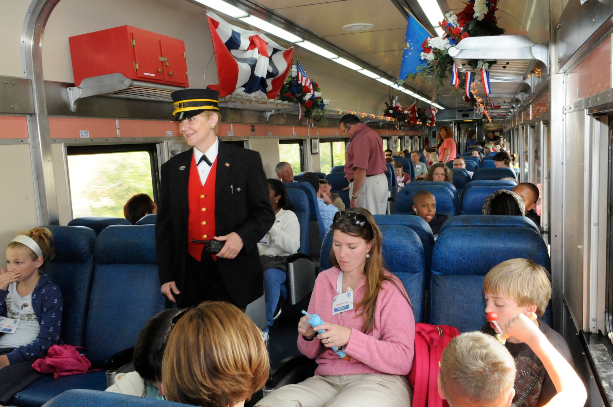 Marybeth Kelly, the trainline's first female trainman, walks the aisles during the trip. U. S. Air Force photo by Sue Sapp