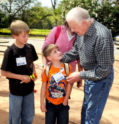Pres. Carter wishes Rylin Lewis happy birthday while his brother Matt looks on.  Rylin turned 6 on the day he met the former president.  U. S. Air Force photo by Sue Sapp