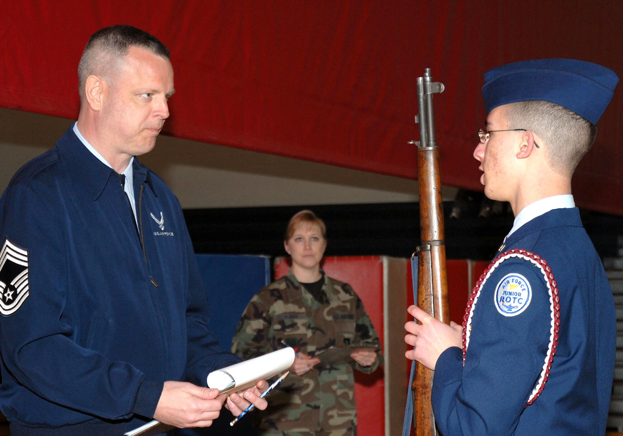 Chief Master Sgt. Michael J. Stephenson listens as an Air Force Junior ROTC cadet from Lebanon High School, Ohio, requests that his flight be allowed to use the drill floor for the armed exhibition at a junior ROTC drill team championships March 29 at Walter E. Stebbins High School in Riverside, Ohio. Chief Stephenson is the National Air and Space Intelligence Center superintendent from Wright-Patterson Air Force Base, Ohio. (U.S. Air Force photo/Master Sgt Bonnie A. White)
