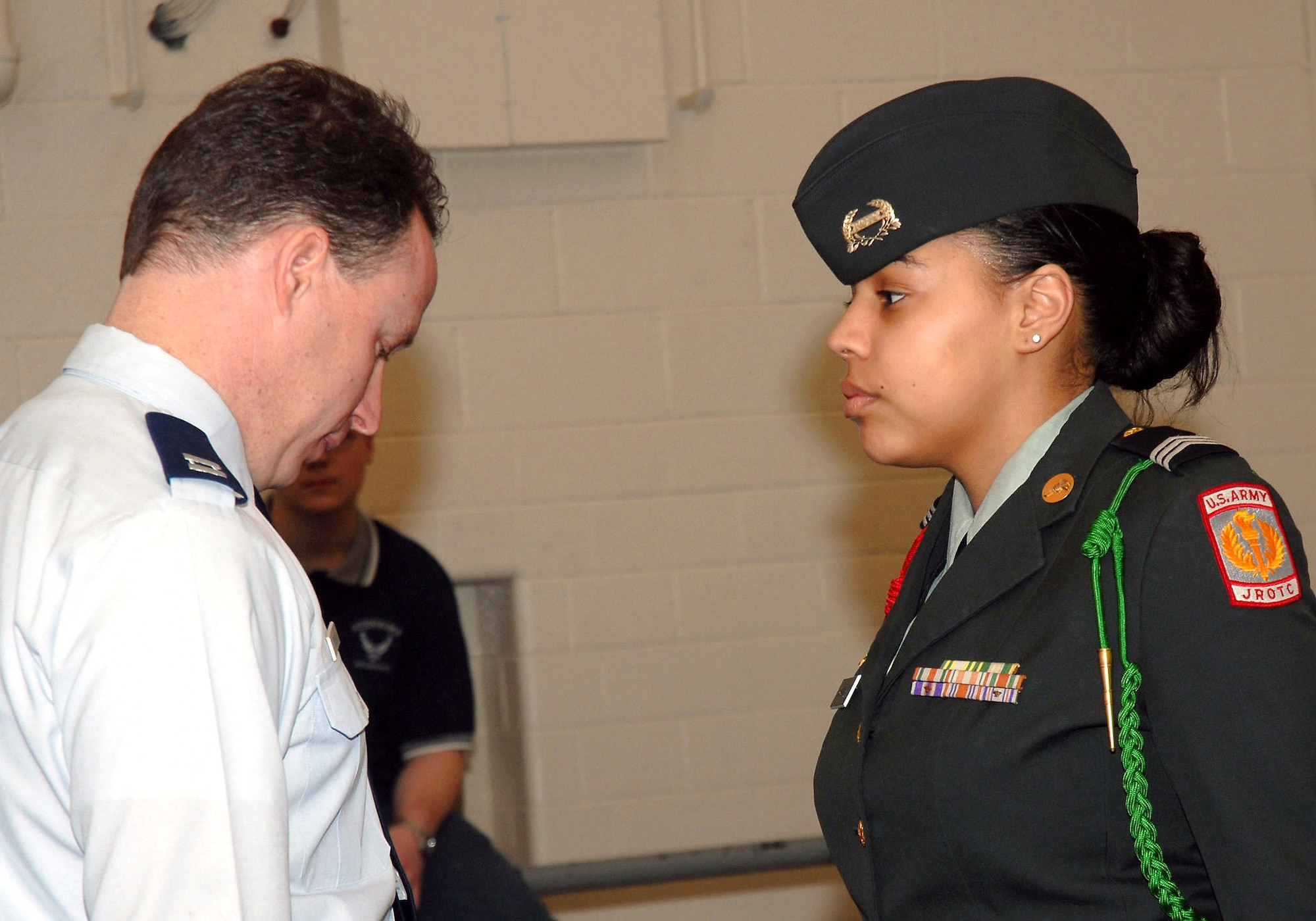 Capt. Rick Ernest inspects an Army junior ROTC cadet's uniform during an open ranks inspection at a junior ROTC drill team championships March 29 at Walter E. Stebbins High School in Riverside, Ohio. Captain Ernest is a meterologists at the National Air and Space Intelligence Center from Wright-Patterson Air Force Base, Ohio. (U.S. Air Force photo/Master Sgt. Bonnie A. White)
