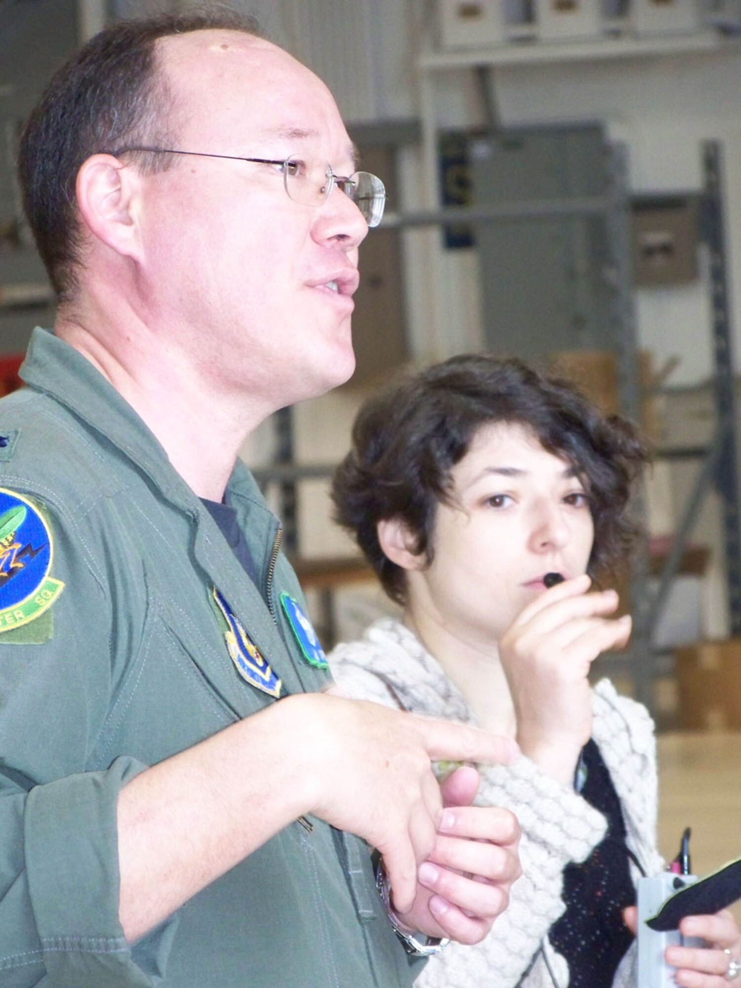Lt. Col. John Lipps, 47th Fighter Squadron, speaks and Yulia Tsaplina interprets to Russian judges and their American hosts, during the judges' Wing tour Thursday, April 3.  (U.S. Air Force photo/Master Sgt. Sherri Bohannon)