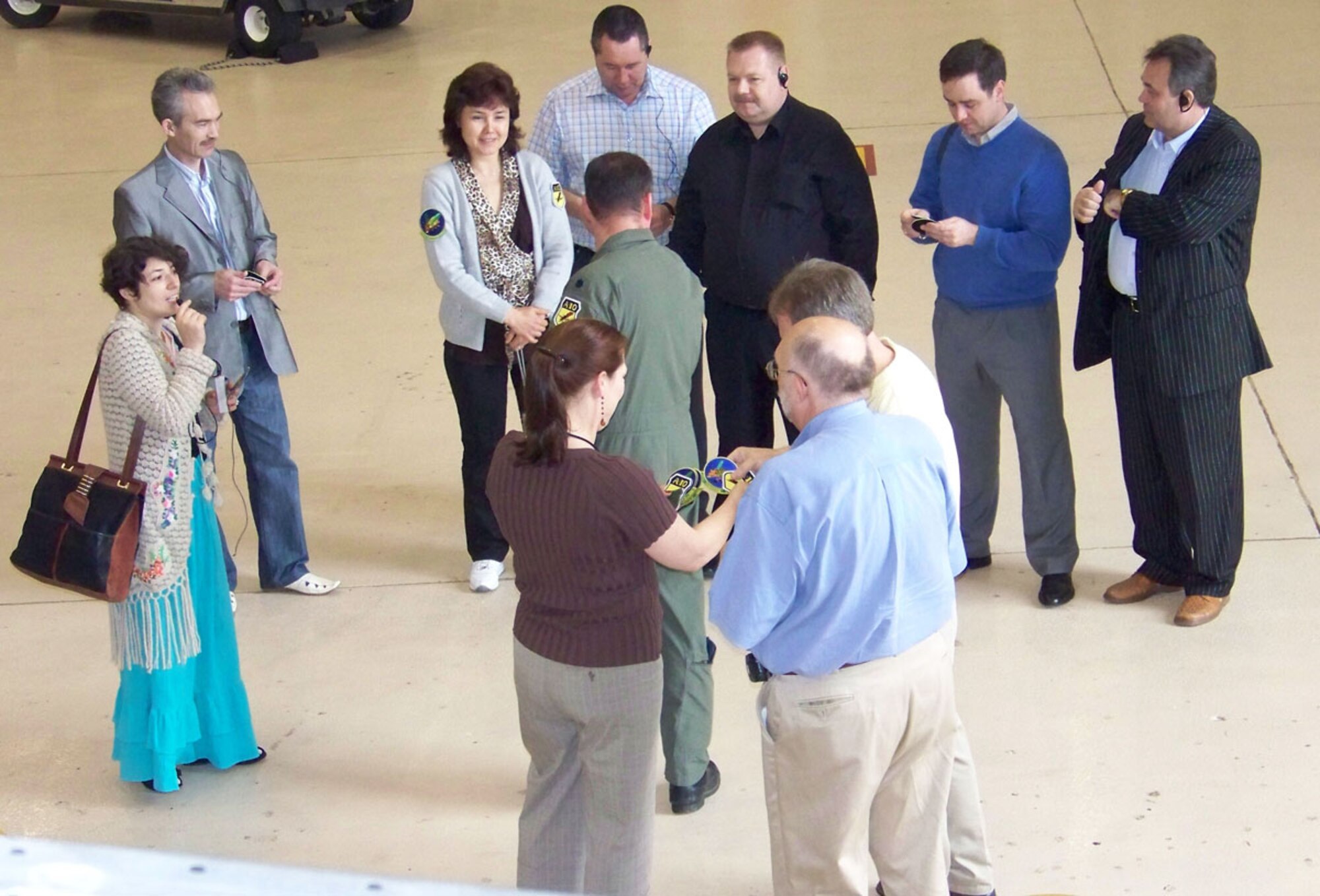 Jessica D'Aurizio (pictured in brown shirt) and Lt. Col. John Lipps, 917th Wing, pass out A-10 and 47th Fighter Squadron patches out to Russian judges and their American hosts during their Wing tour Thursday, April 3. (U.S. Air Force photo/Master Sgt. Sherri Bohannon)