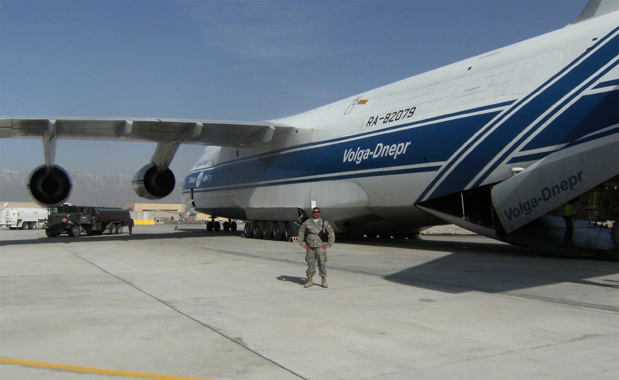 SEYMOUR JOHNSON AIR FORCE BASE, N.C. -- Capt. Neil Chandler, Reservist with the 916th Logistics Readiness Squadron, stands next to the largest cargo aircraft in the world while deployed to Afghanistan.  The AN124 is a civilian Russian cargo plane and can sometimes be viewed at various American airshows. This particular plane was delivering the Mine Resistant Ambush Protected vehicle to Afghanistan. 