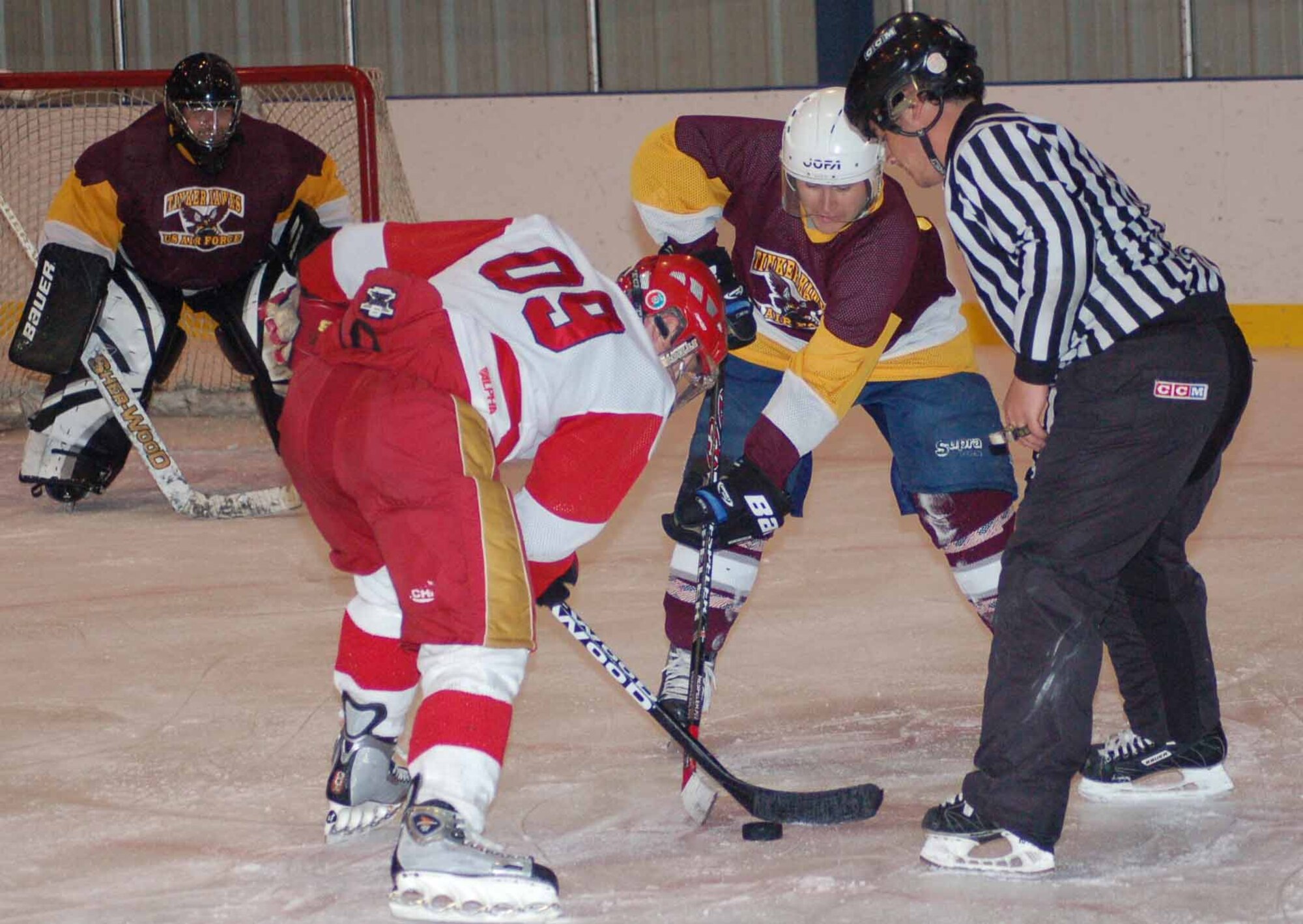 Tinker Hawks center James Behn battles with Canadians A center Bill Chirch during a face off in the first period of a March 30 game at the Arctic Edge Ice Arena in Edmond.  The Canadians won the game 5-2.  (Air Force photo by John E. Banks)