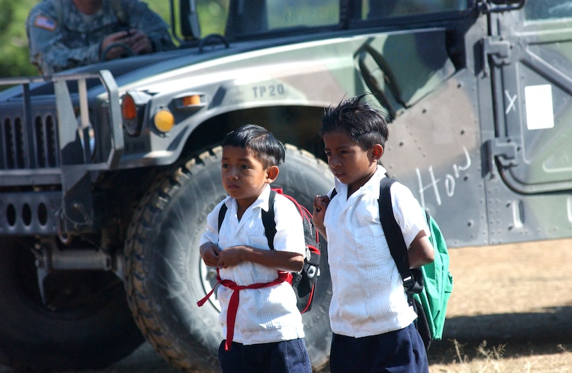 Two young boys wait near a HumVee for festivities to begin at the opening ceremony for Beyond the Horizon 2008 April 1.