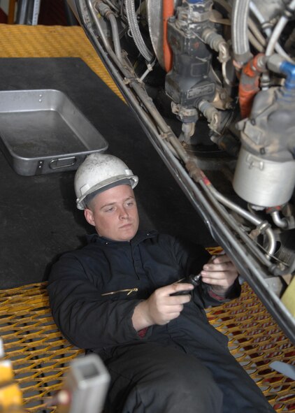 DYESS AIR FORCE BASE, Texas -- Airman 1st Class Justin Tomkins begins to work on a C-130 engine, April 2. An aircraft engine mechanic is responsible for de-paneling, checking, and fixing every last part in an engine. (U.S. Air Force photo Airman 1st Class Jennifer Romig)