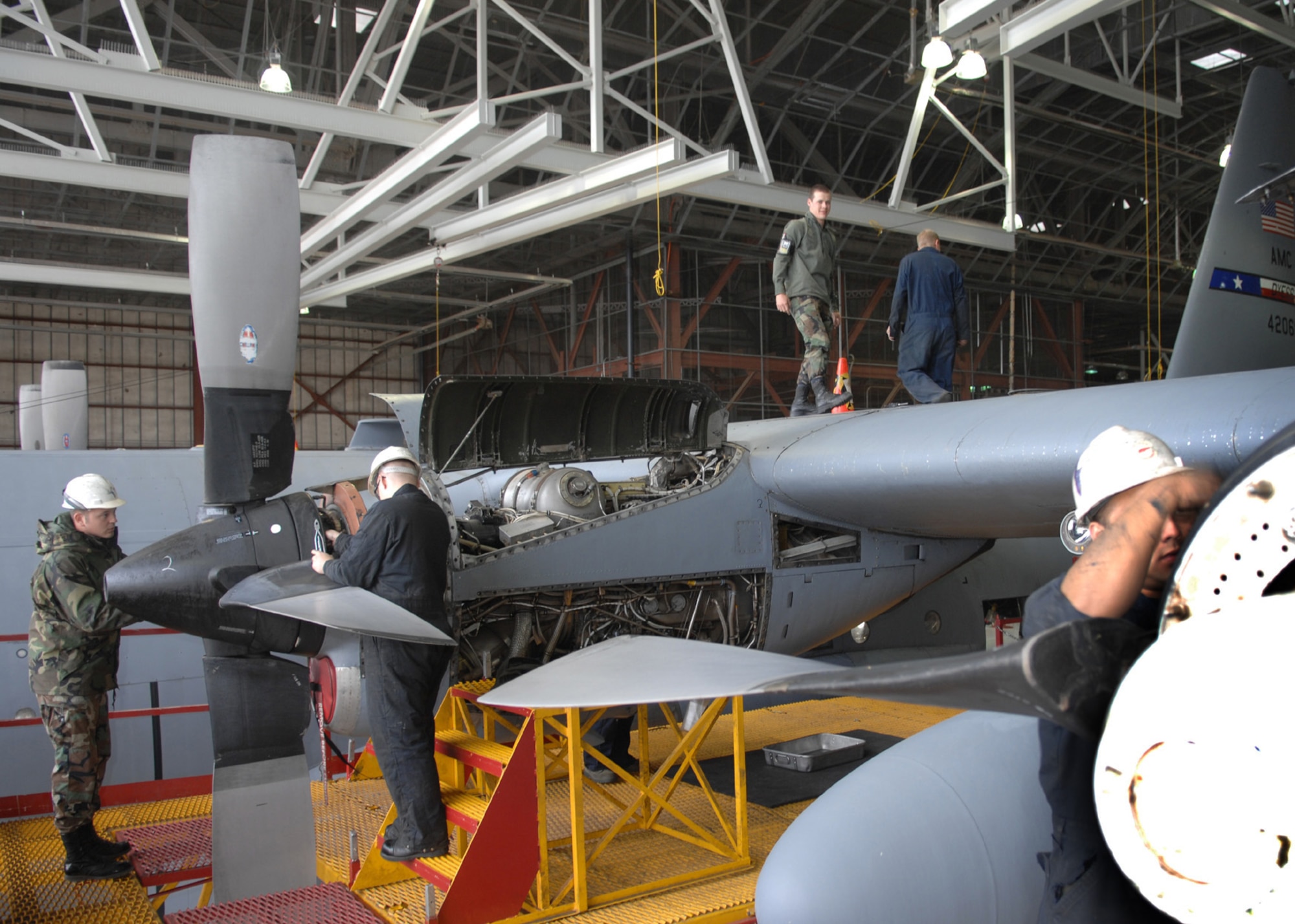 DYESS AIR FORCE BASE, Texas -- A team of Airmen work together to de-panel a C-130, April 2. When an aircraft comes into a hangar many crew chiefs and engine mechanics are needed to help repair the plane. (U.S. Air Force photo Airman 1st Class Jennifer Romig)