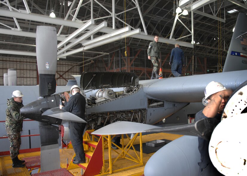 DYESS AIR FORCE BASE, Texas -- A team of Airmen work together to de-panel a C-130, April 2. When an aircraft comes into a hangar many crew chiefs and engine mechanics are needed to help repair the plane. (U.S. Air Force photo Airman 1st Class Jennifer Romig)