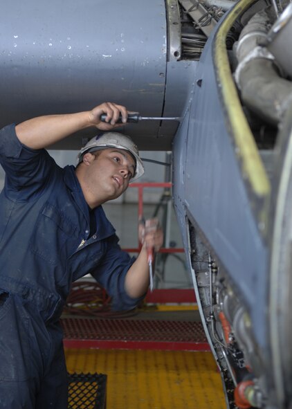 DYESS AIR FORCE BASE, Texas -- Airman 1st Class Kevin Poulton loosens screws on an engine panel, April 2. After all de-paneling is done, the engine mechanics work in two-man teams and must inspect even the smallest screws to ensure the engine will work properly again. (U.S. Air Force photo Airman 1st Class Jennifer Romig)