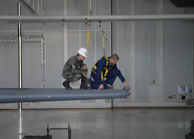 DYESS AIR FORCE BASE, Texas -- Airman 1st Class  Zachary Hamman (right) and Airman 1st Class Seth Duggan inspects the tip of a C-130 tail, April 2. Crew chiefs must inspect an aircraft after every mission from the tip of the nose to the tail. They also clean out all equipment from the inside such as chains, cargo seats and stands. (U.S. Air Force photo Airman 1st Class Jennifer Romig)