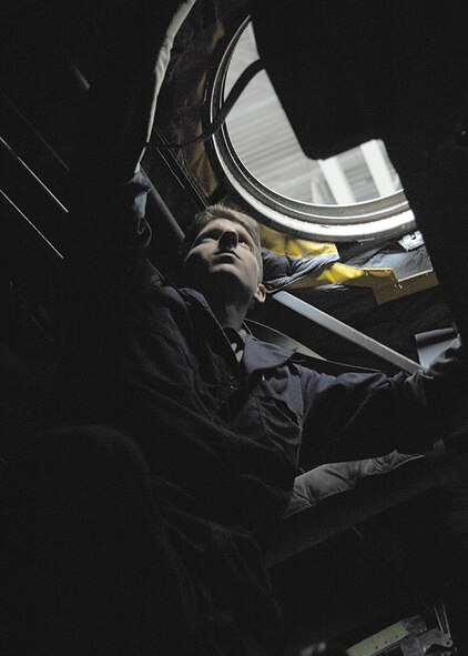 DYESS AIR FORCE BASE, Texas -- Airman 1st Class Dustin Gillespie removes an upper hatch to a C-130, April 2. As a crew chief dissembles an aircraft they must look for dents, scratches and any broken items they will need to fix later. (U.S. Air Force photo Airman 1st Class Jennifer Romig)