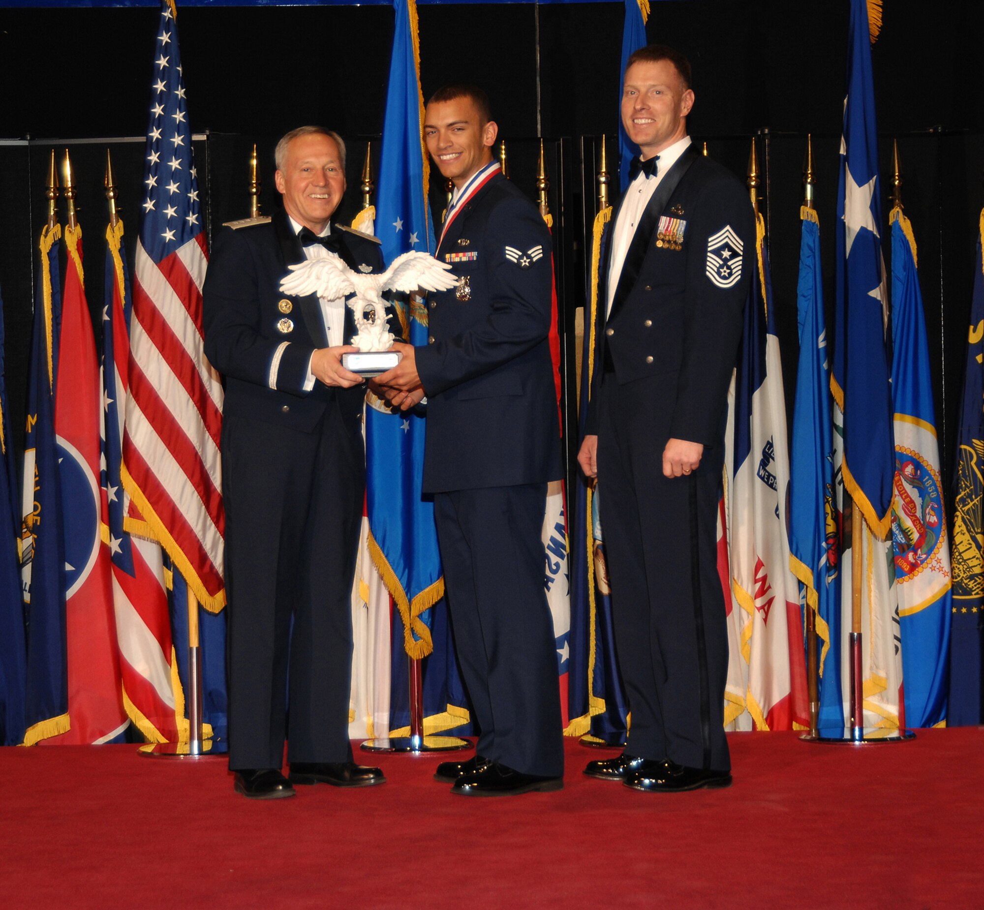 Air Force Materiel Command’s Airman of the Year, Senior Airman Jeremy J. Dixon (center), poses with Gen. Bruce Carlson, AFMC commander (left), and Chief Master Sgt. William C. Gurney, command chief for AFMC. Airman Dixon is assigned to the 775th Civil Engineer Squadron, Hill Air Force Base, Utah. He was selected from nine nominees during a ceremony at the National Museum of the U.S. Air Force April 2. (Air Force photo by Ben Strasser)