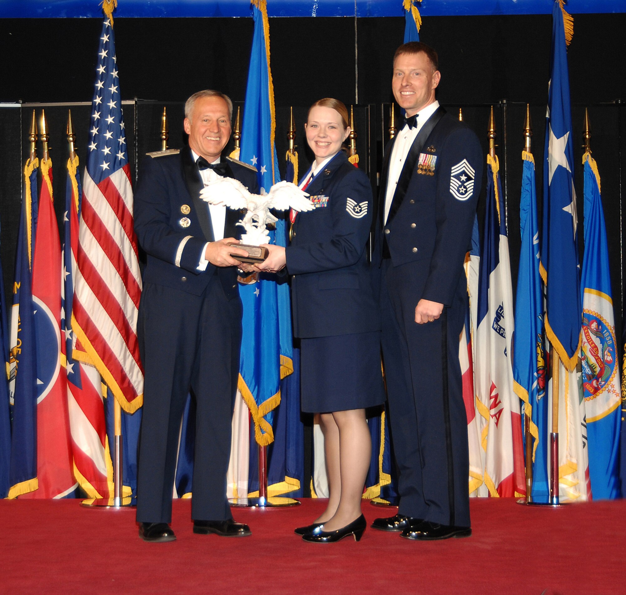 Air Force Materiel Command’s Noncommissioned Officer of the Year, Tech. Sgt. Tammy K. Shaw (center), poses with Gen. Bruce Carlson, AFMC commander (left), and Chief Master Sgt. William C. Gurney, command chief for AFMC. Sergeant Shaw is assigned to the 88th Diagnostics and Therapeutics Squadron, Wright-Patterson Air Force Base, Ohio. She was selected from 11 nominees during a ceremony at the National Museum of the U.S. Air Force April 2. (Air Force photo by Ben Strasser)