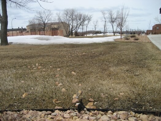 GRAND FORKS AIR FORCE BASE, N.D. - Now that the snow is receding, rocks, sticks, and other debris pose a safety threat. To prevent injury and eliminate these hazards, rake lawns before mowing. (Courtesy photo) 
