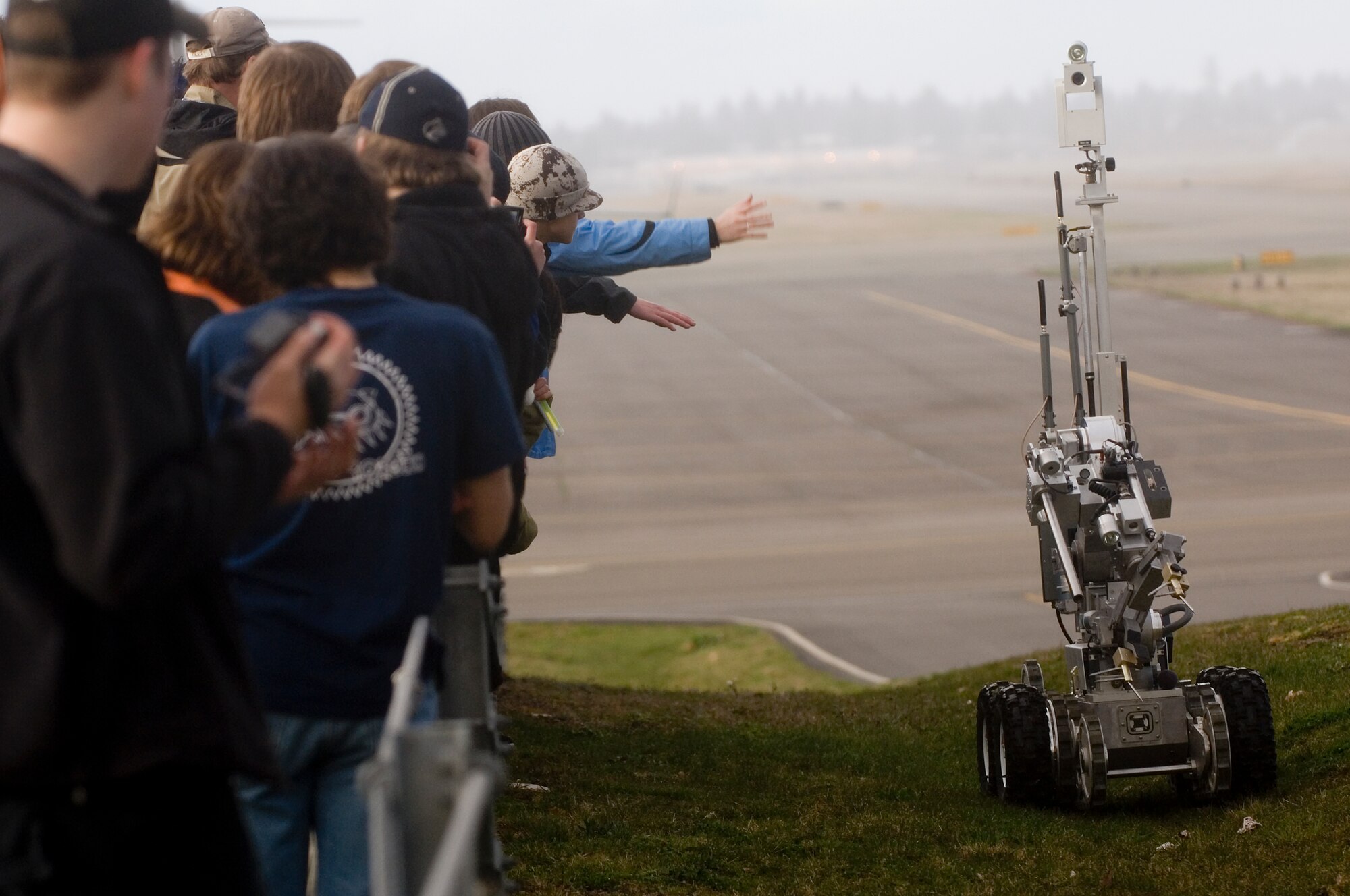 Local high school students watch as a remote controlled Andros F6 robot from the 62nd Civil Engineer Squadron’s Explosive Ordinance Disposal flight works its way up a hill during a demonstration on the flightline. The students were visiting McChord March 24 as part of a robotic competition sponsored by For Inspiration and Recognition of Science and Technology, or FIRST.
(U.S. Air Force photo/Abner Guzman)