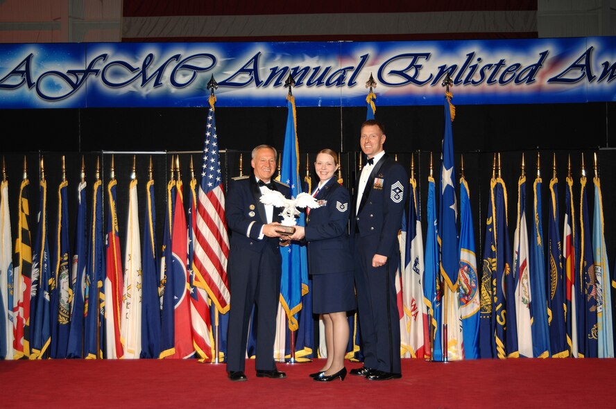 Tech. Sgt. Tammy Shaw, of the 88th Diagnostics and Therapuetics Squadron, stands with Gen. Bruce Carlson, AFMC commander, and Chief Master Sgt. William C. Gurney, command chief for AFMC, to accept her award for the top NCO at the  2008 AFMC Outstanding Airmen of the Year awardsceremony, held Wednesday evening at the National Museum of the United States Air Force.  (Air Force photo by Ben Strasser)
