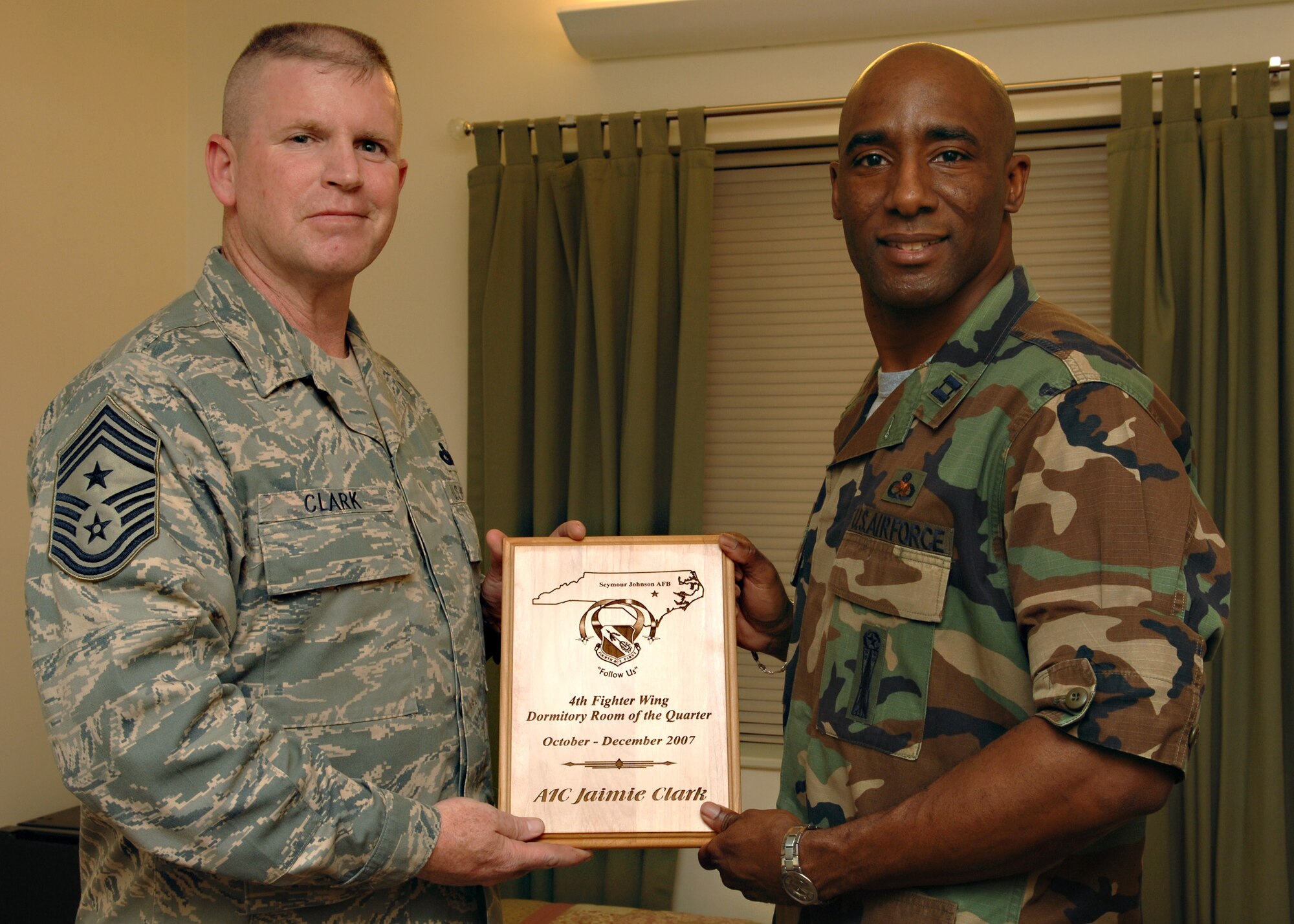 Chief Master Sergeant Layton Clark, Command Chief of the 4th Fighter Wing, presents a plaque to Captain Kenneth Sumler, 4th Component Maintenance Squadron Maintenance Officer, at Seymour Johnson AFB, North Carolina, March 28, 2008.  Captain Sumler was accepting the award on behalf of Airman First Class Jamie Clark, 4th Component Maintenance Squadron, who won the Room of the Quarter at Building 3652. 

(US Air Force photo by Airman First Class Salma Din)(Released) 
