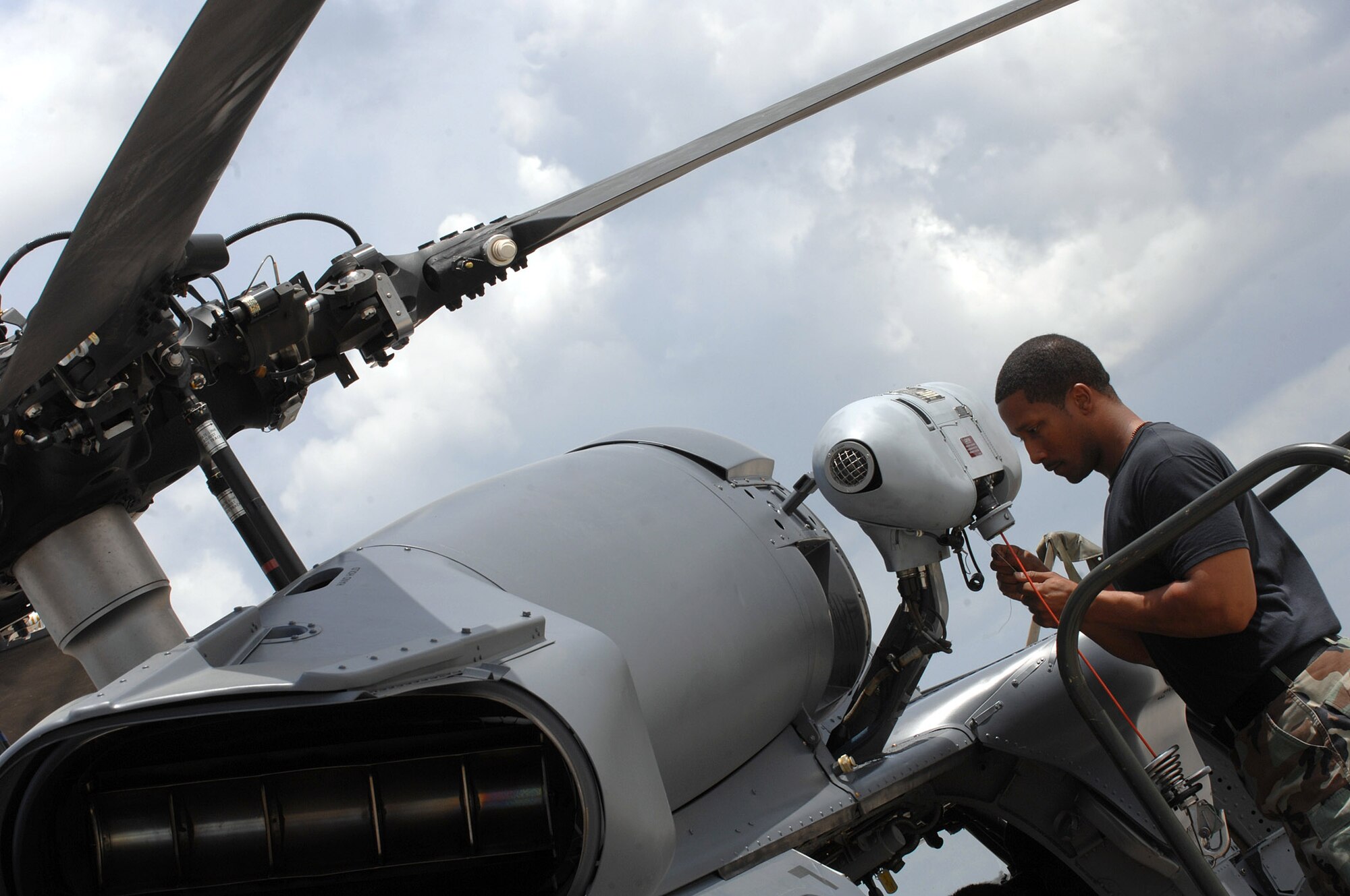 Staff Sgt. Ray Campbell installs a hoist cable squib April 1 on an HH-60G Pave Hawk helicopter at Moody Air Force Base, Ga.  A hoist cable squib is an explosive device that cuts through the cable in an emergency.  Sergeant Campbell is an electrical and environmental technician with the 723rd Aircraft Maintenance Squadron.  (U.S. Air Force photo/Airman 1st Class Brittany Barker)
