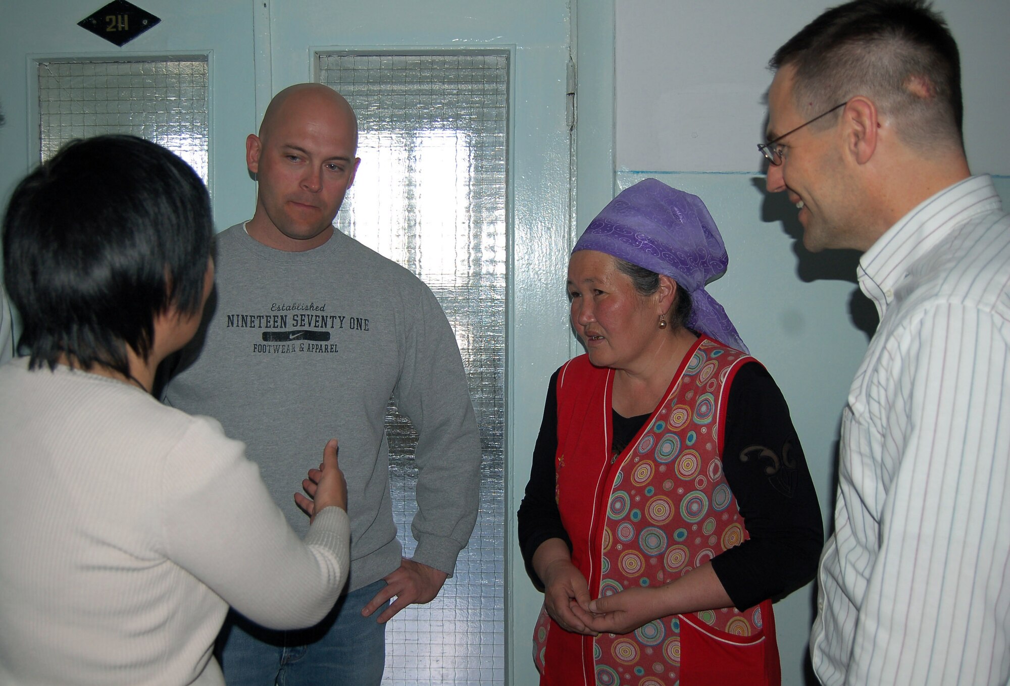 Master Sgt. Scott Kaulig talks with Sakin Tumenbaeva, the mother of the 100th heart surgery patient, Alymbekov Amanbek, through Aigul Karymshakova, a 376th Air Expeditionary Wing interpreter, March 29 in the Children's Heart Ward in Manas, Kyrgyzstan. Airmen from the Manas Air Base Outreach Society visited the Children's Heart Ward to celebrate the 100th heart surgery and meet the staff and patients. Sergeant Kaulig is the 376th Aircraft Maintenance Squadron KC-135 Stratotanker section chief. (U.S. Air Force photo/Tech. Sgt. Jerome Baysmore)
