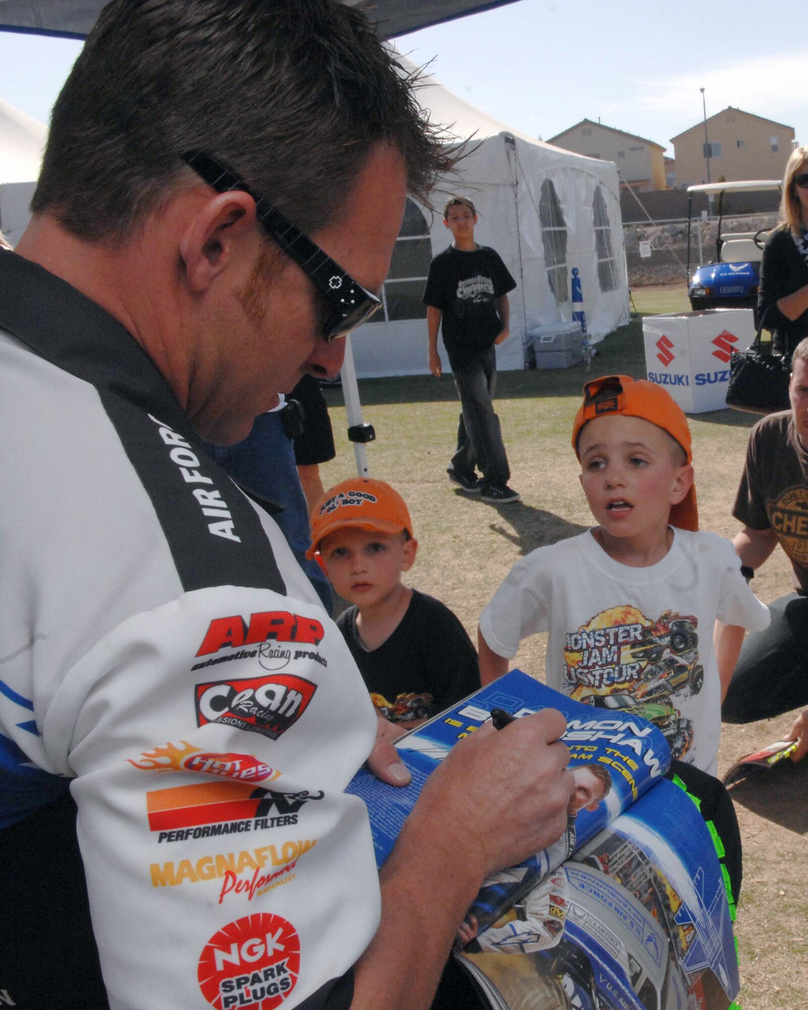 Damon Bradshaw signs autographs for young fans at the Monster Jam World Finals March 29 in Las Vegas. Mr. Bradshaw is the driver of the Air Force Afterburner monster truck (U.S. Air Force photo/Senior Airman Larry E. Reid Jr.) 
