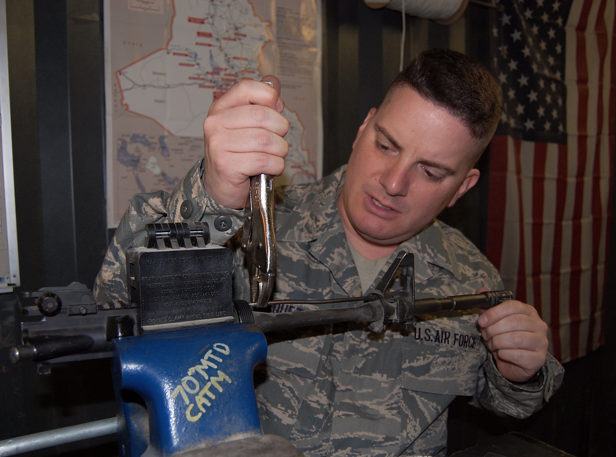 SOUTHWEST ASIA -- Master Sgt. Joseph Vasquez, NCO in charge of the 70th Medium Truck Detachment armory performs maintenance recently on one of the weapons vehicle operators assigned to the 586th Expeditionary Logistics Readiness Squadron use while conducting combat convoy missions in Iraq. Sergeant Vasquez, deployed from the 305th Security Forces Squadron, McGuire Air Force Base, N.J., provides security and accountability of all weapons for the MTD, as well as issuing out weapons for each mission and doing any in-house maintenance on the weapons. (Air Force courtesy photo)