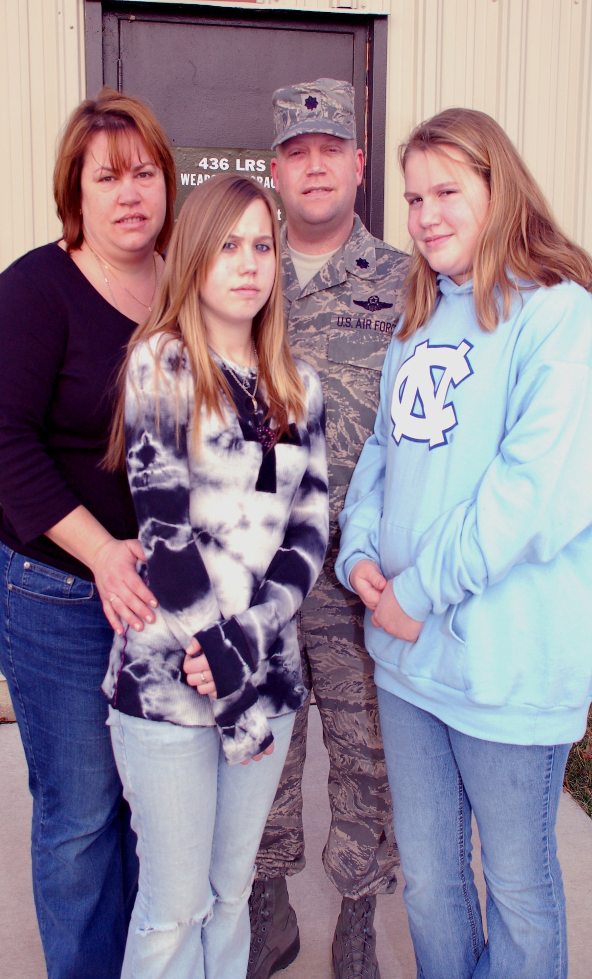 Melody, Ali, Lt. Col. Carl, and Jessi Rahn, gather outside the 436th Logistics Readiness Squadron weapon storage facility on Dover Air Force Base recently. The colonel was issued his weapon and left for a year deployment to Iraq the same day. The Rahn family hope the experience they have dealing with deployment-related stressors can benefit junior members who currently, or will soon endure similar stressors. (U.S. Air Force photo/Tech. Sgt. Kevin Wallace)