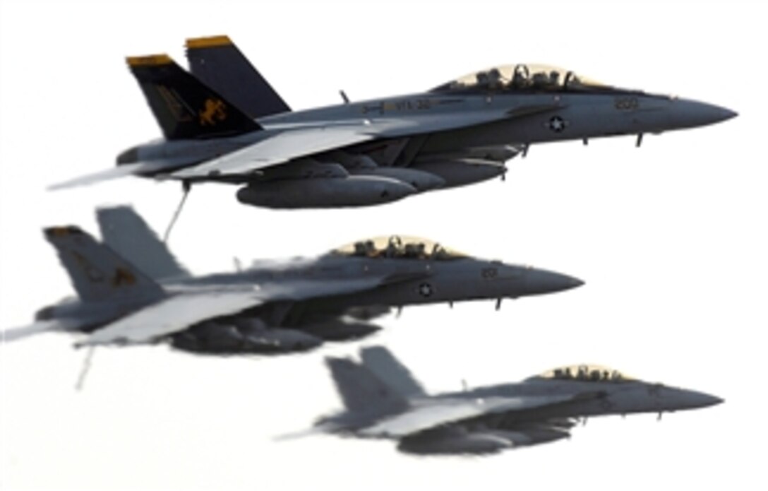 F/A-18F Super Hornets assigned to the "Swordsmen" of Strike Fighter Squadron 32 fly near the Nimitz-class aircraft carrier USS Harry S. Truman during flight operations, April 2, 2008.